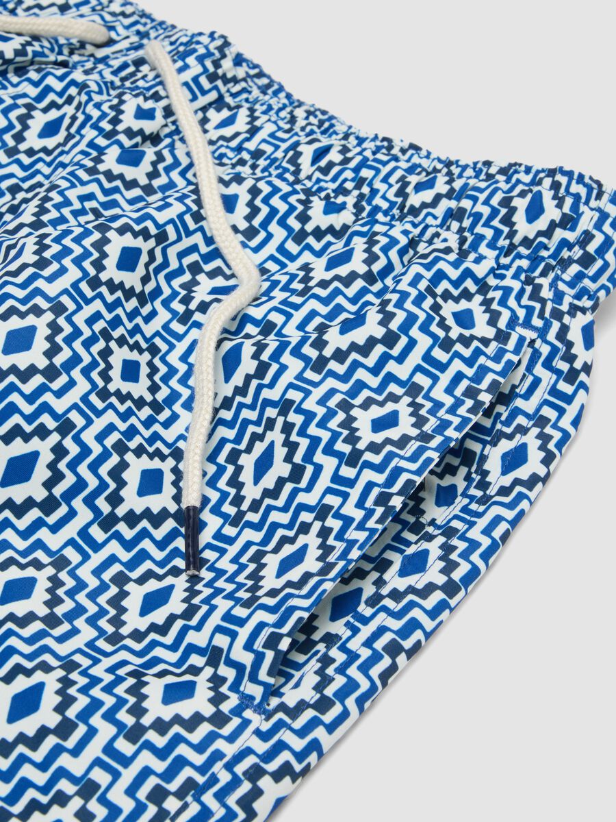 Blue swim shorts with geometric print_5