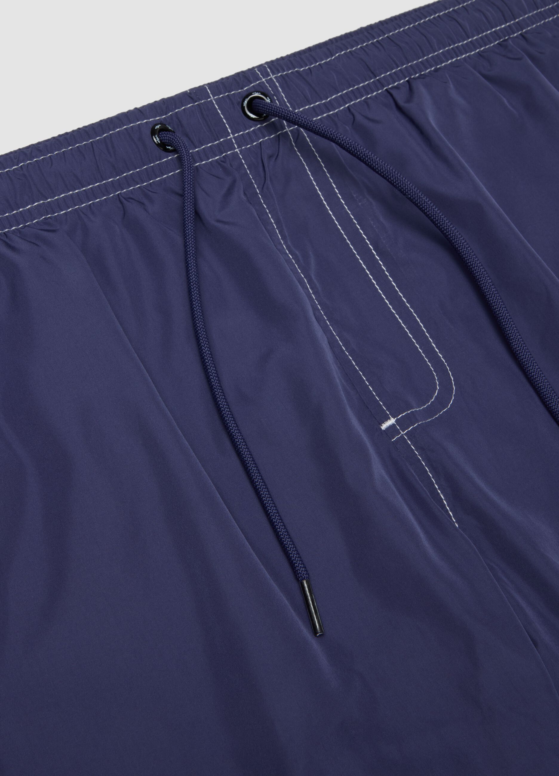 Blue swim shorts with drawstring waist