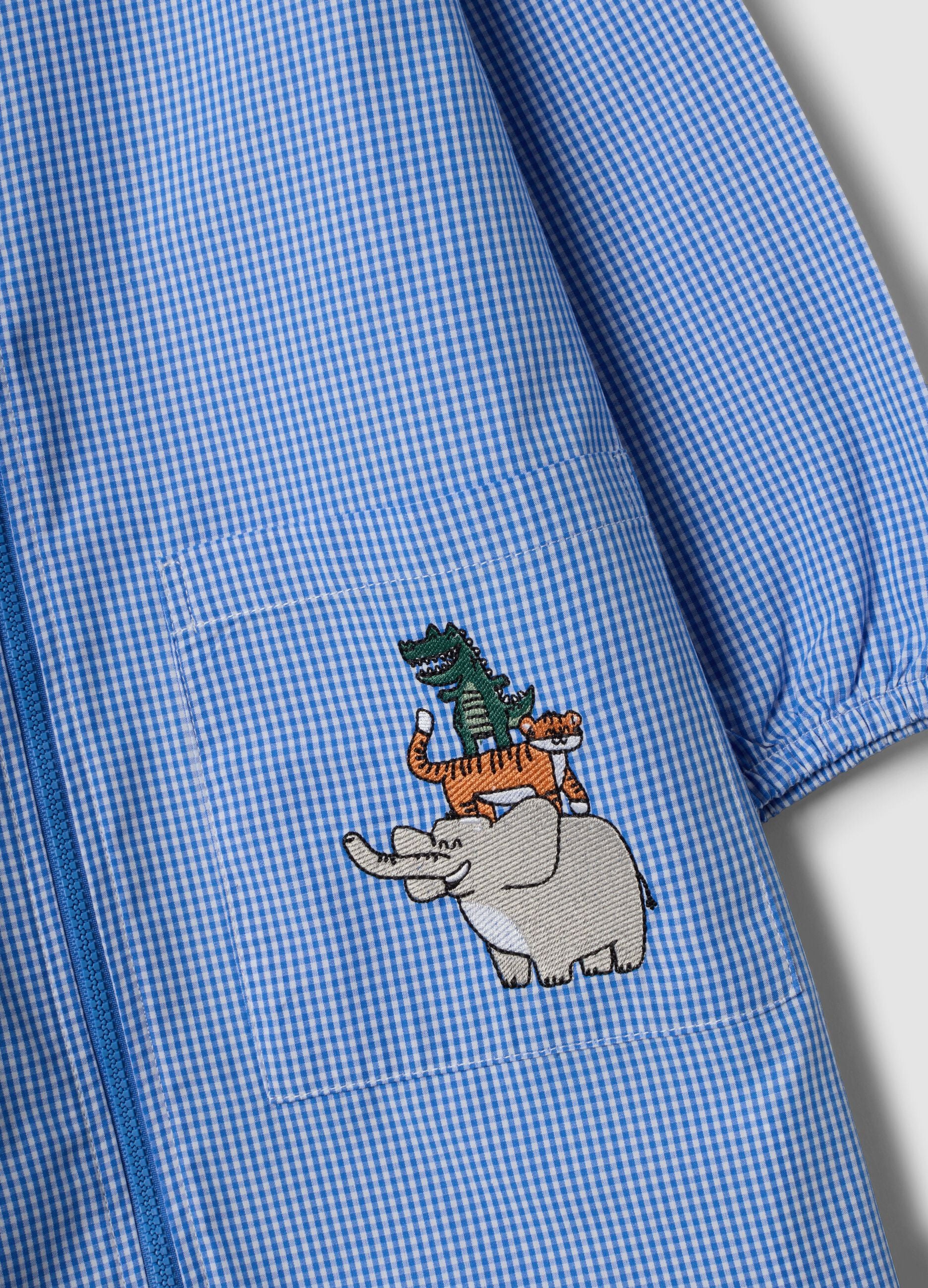 Blue gingham nursery apron with zip and animal embroidery