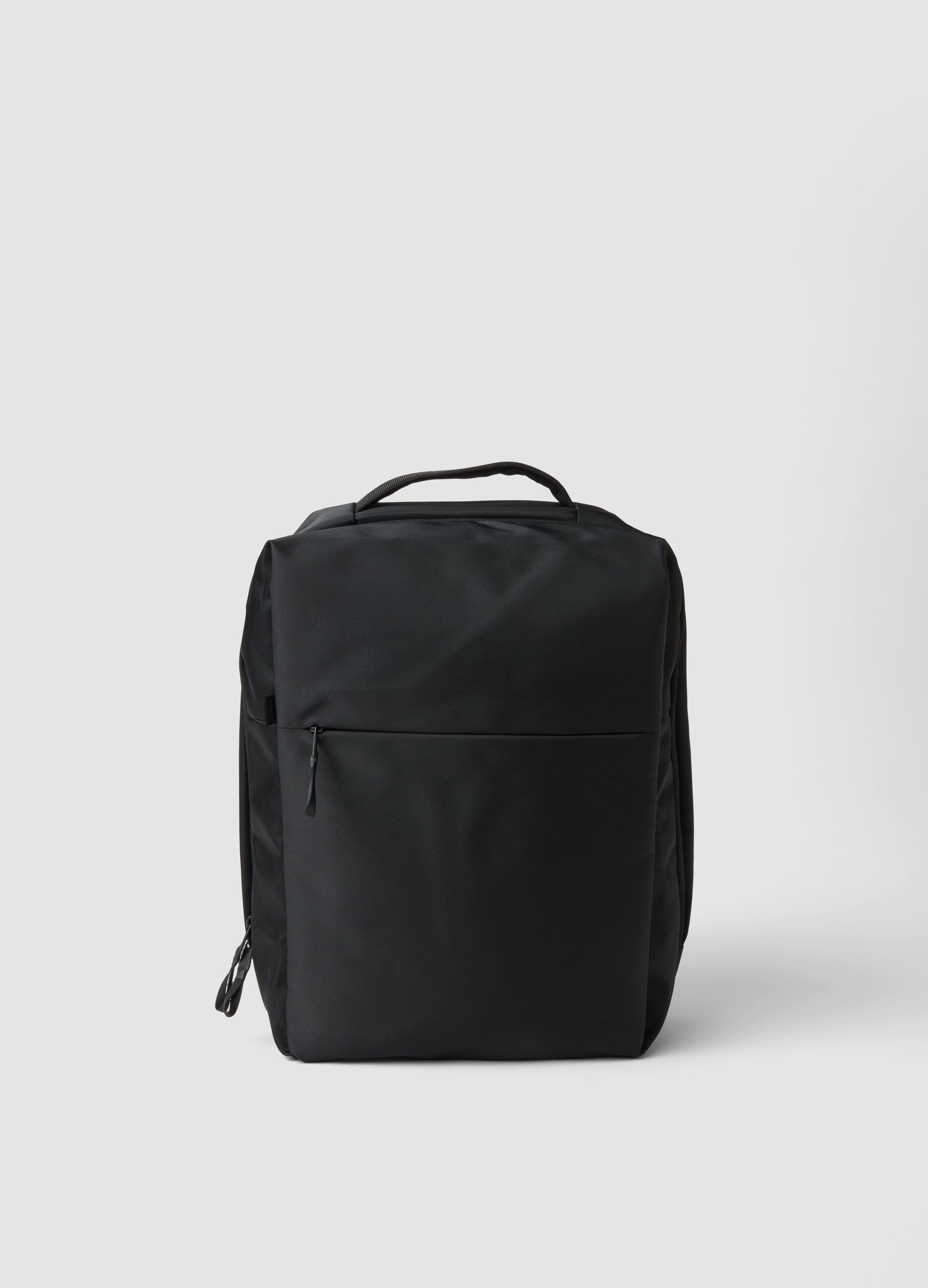 Black water-repellent backpack with front pocket and padded shoulder straps