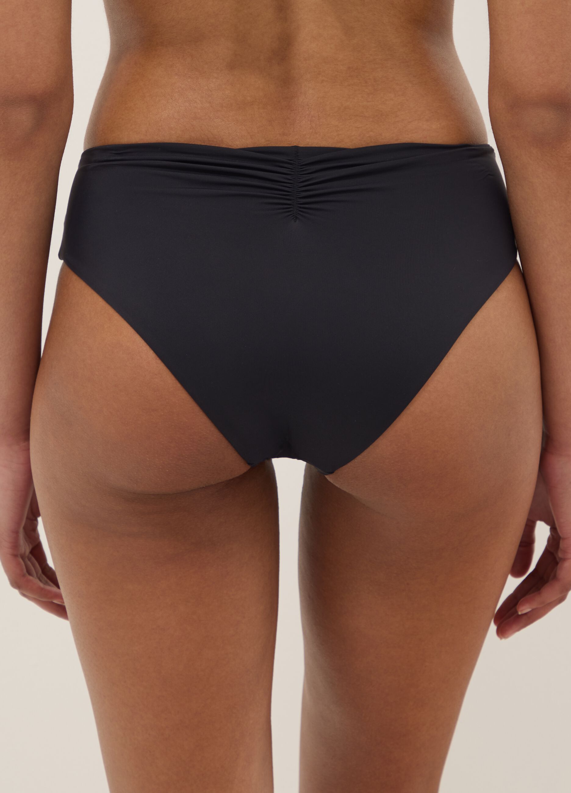 Black stretch swim briefs with embroidered details