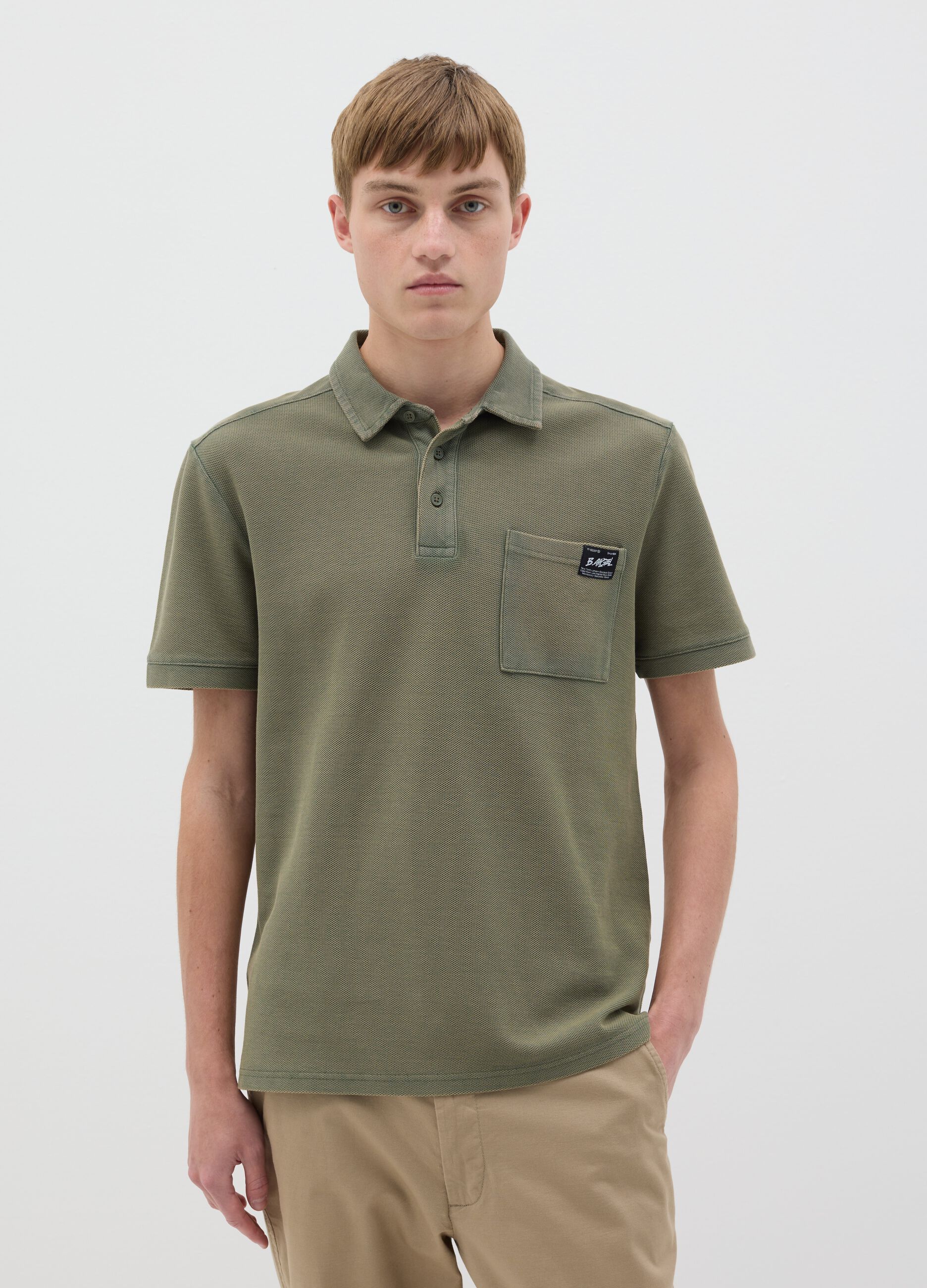 Green short-sleeved polo shirt in cotton piquet