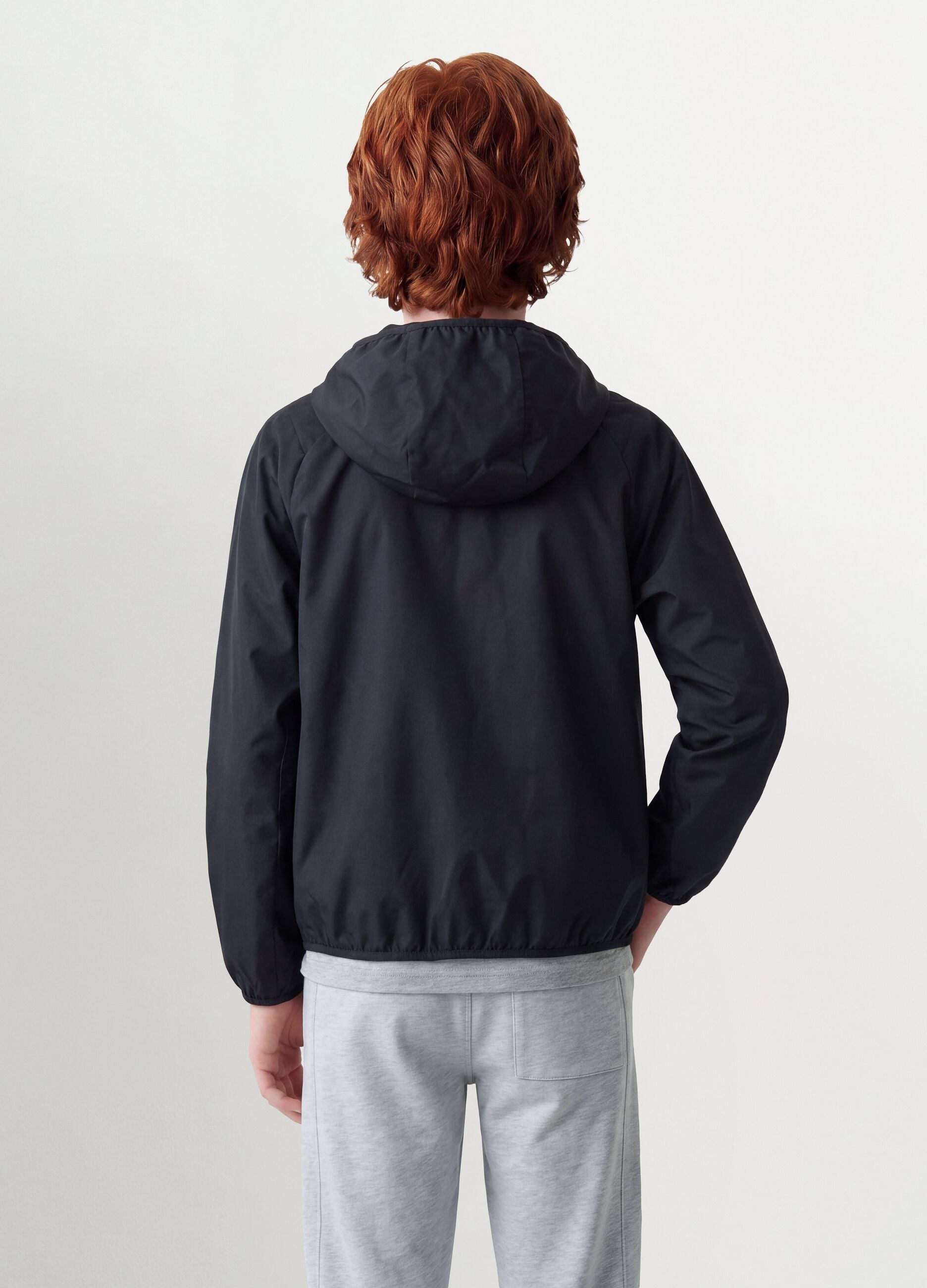 Black oversized rain jacket with hood and zip for boys