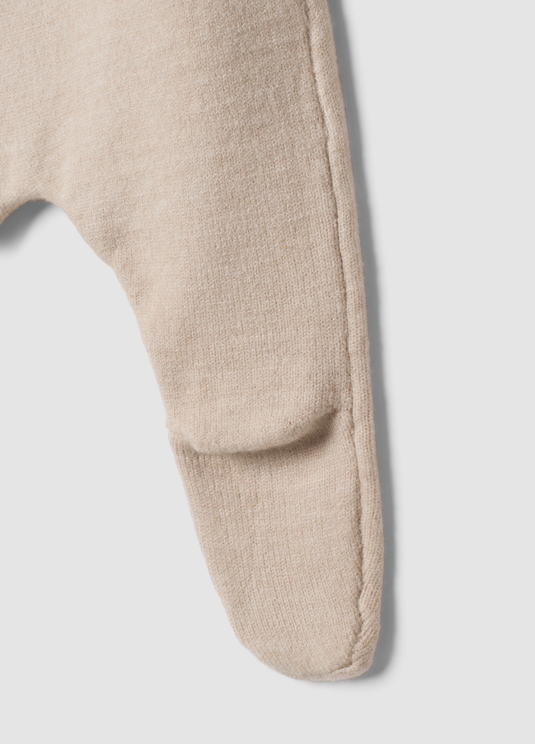 Beige baby sleepsuit with feet and wrap closure