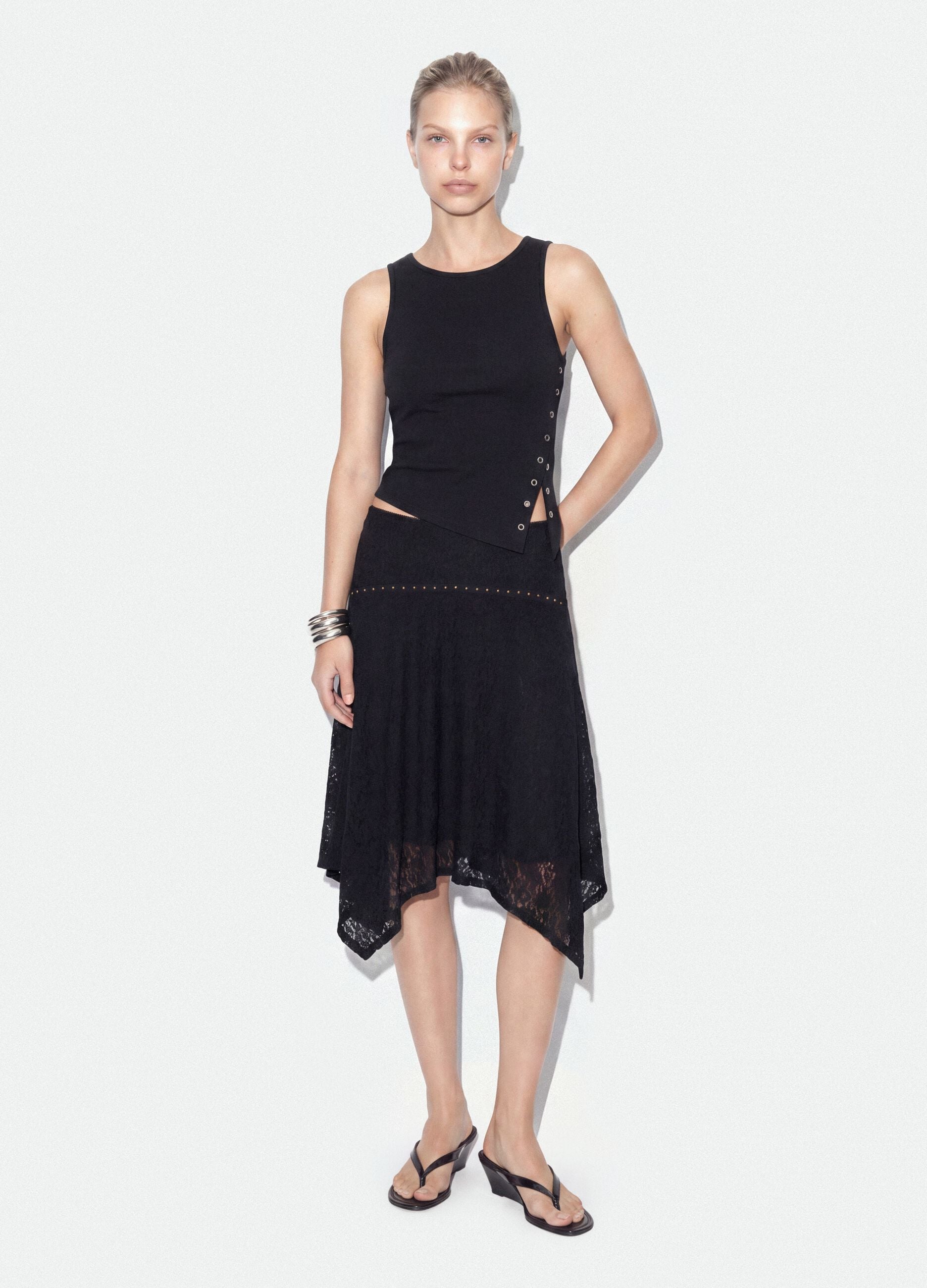 Black stretch skirt with asymmetric lace hem