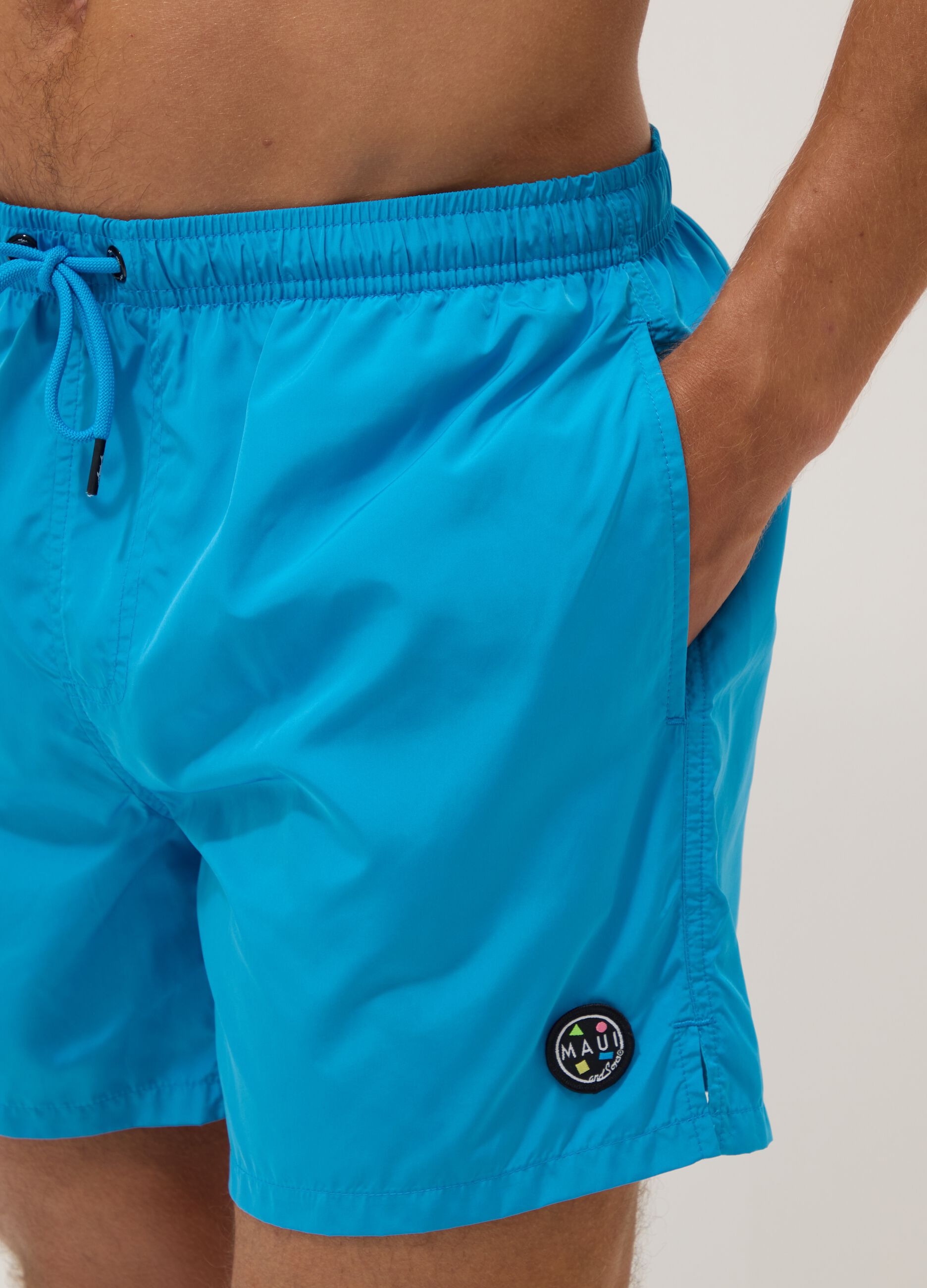 Blue swim shorts with elasticated waist and drawstring