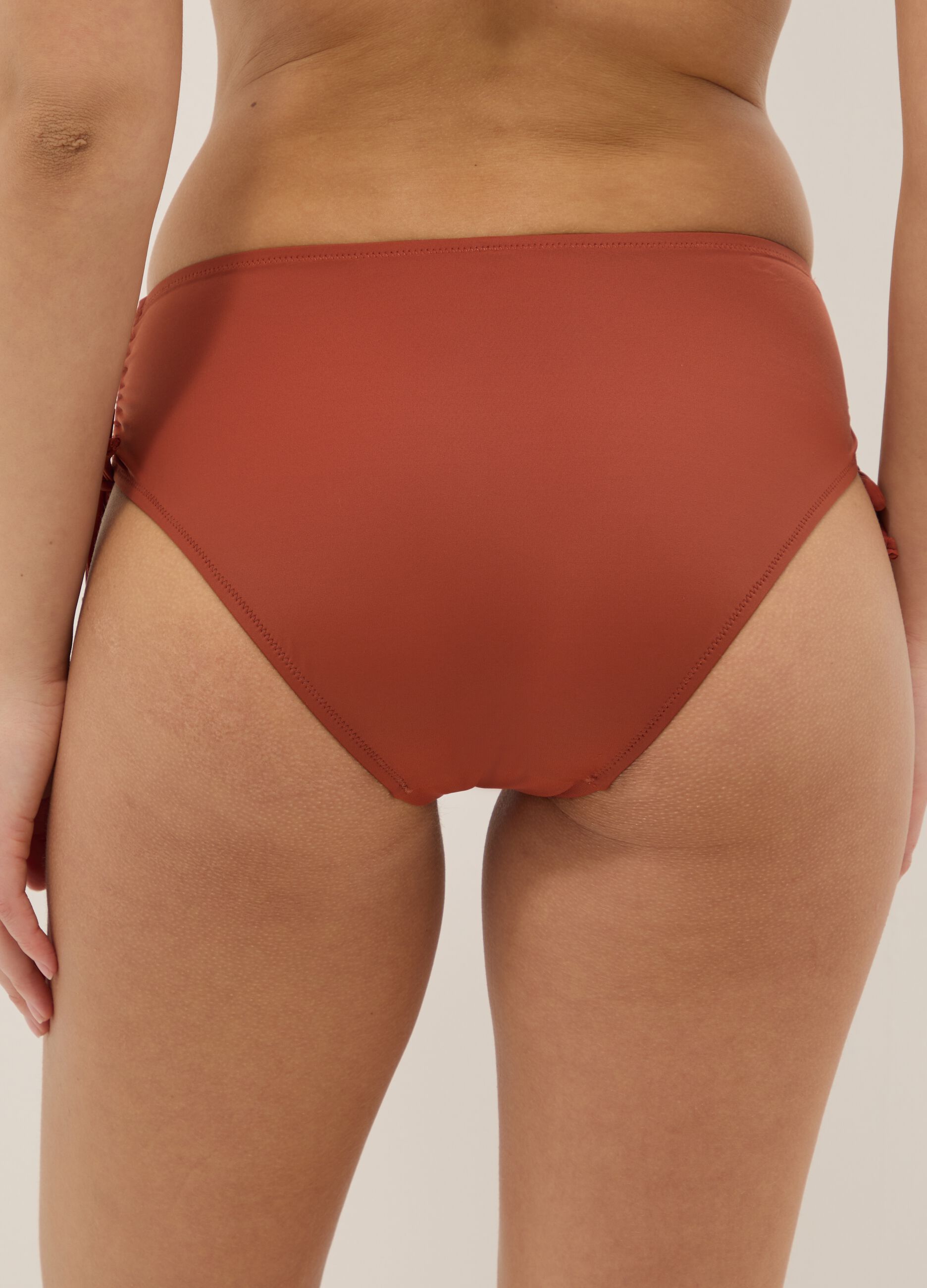 Orange stretch bikini bottoms with ruched side detailing