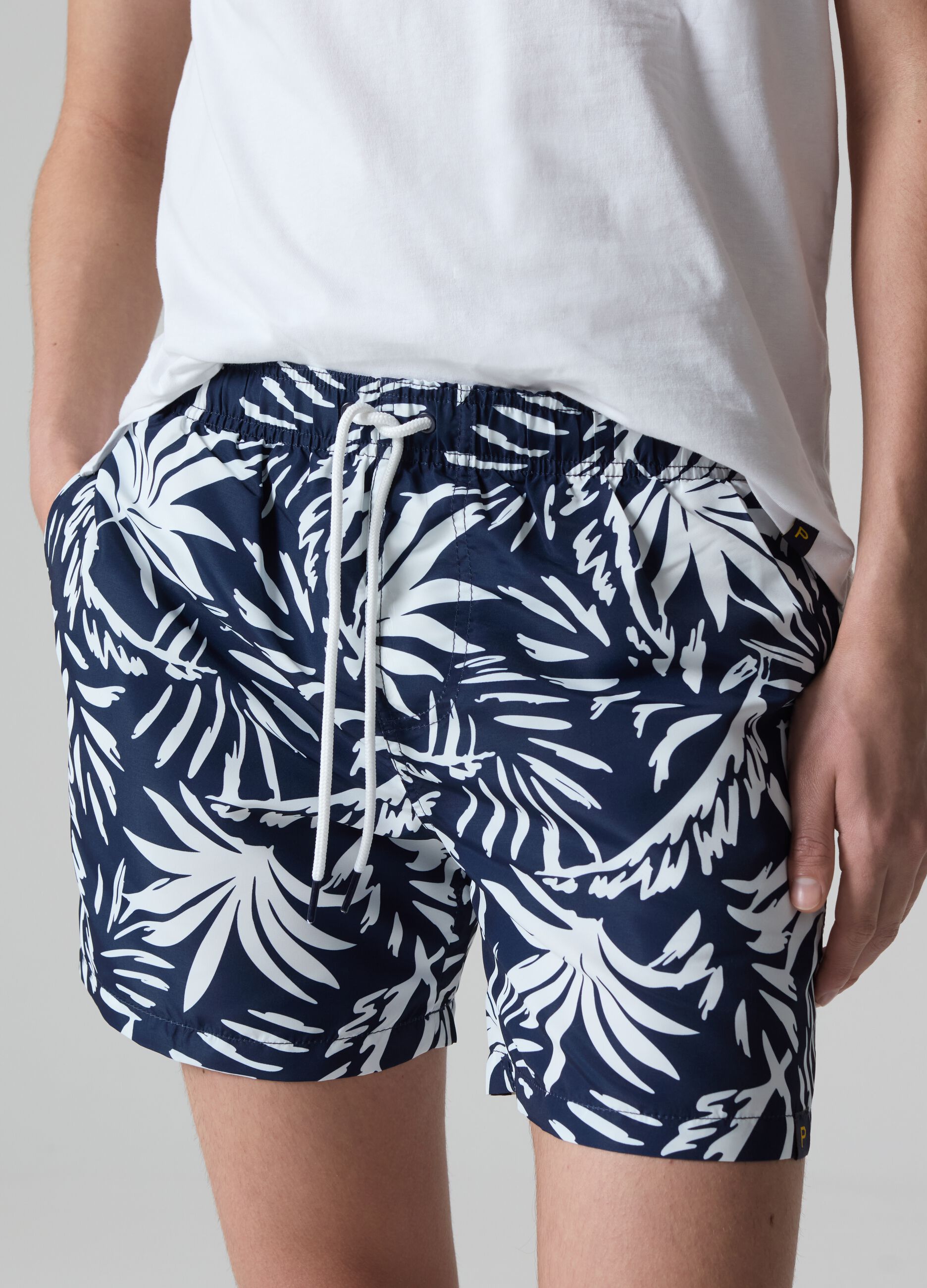Bermuda swim shorts with foliage print