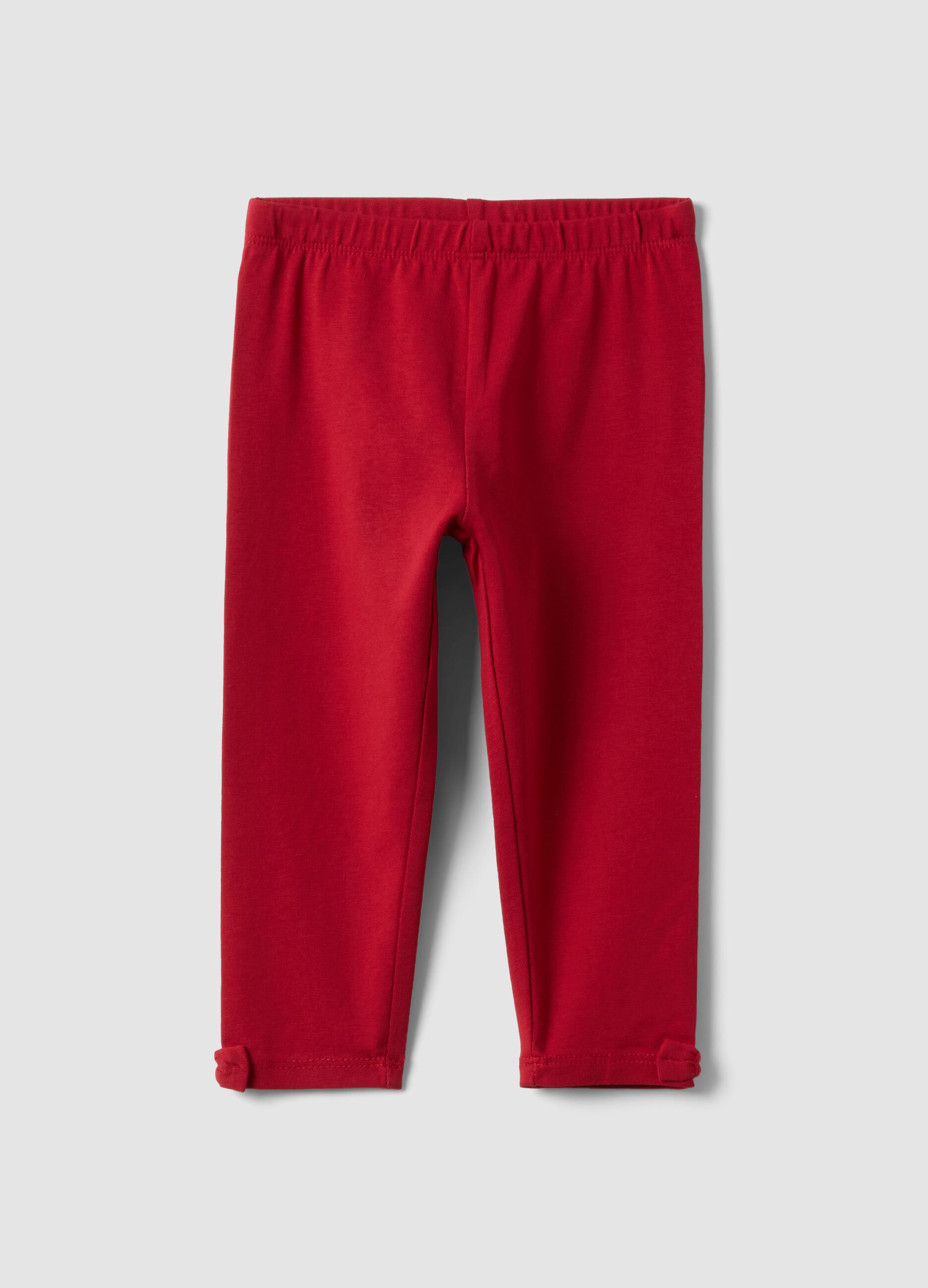 Red stretch organic cotton leggings with bow details for baby girl
