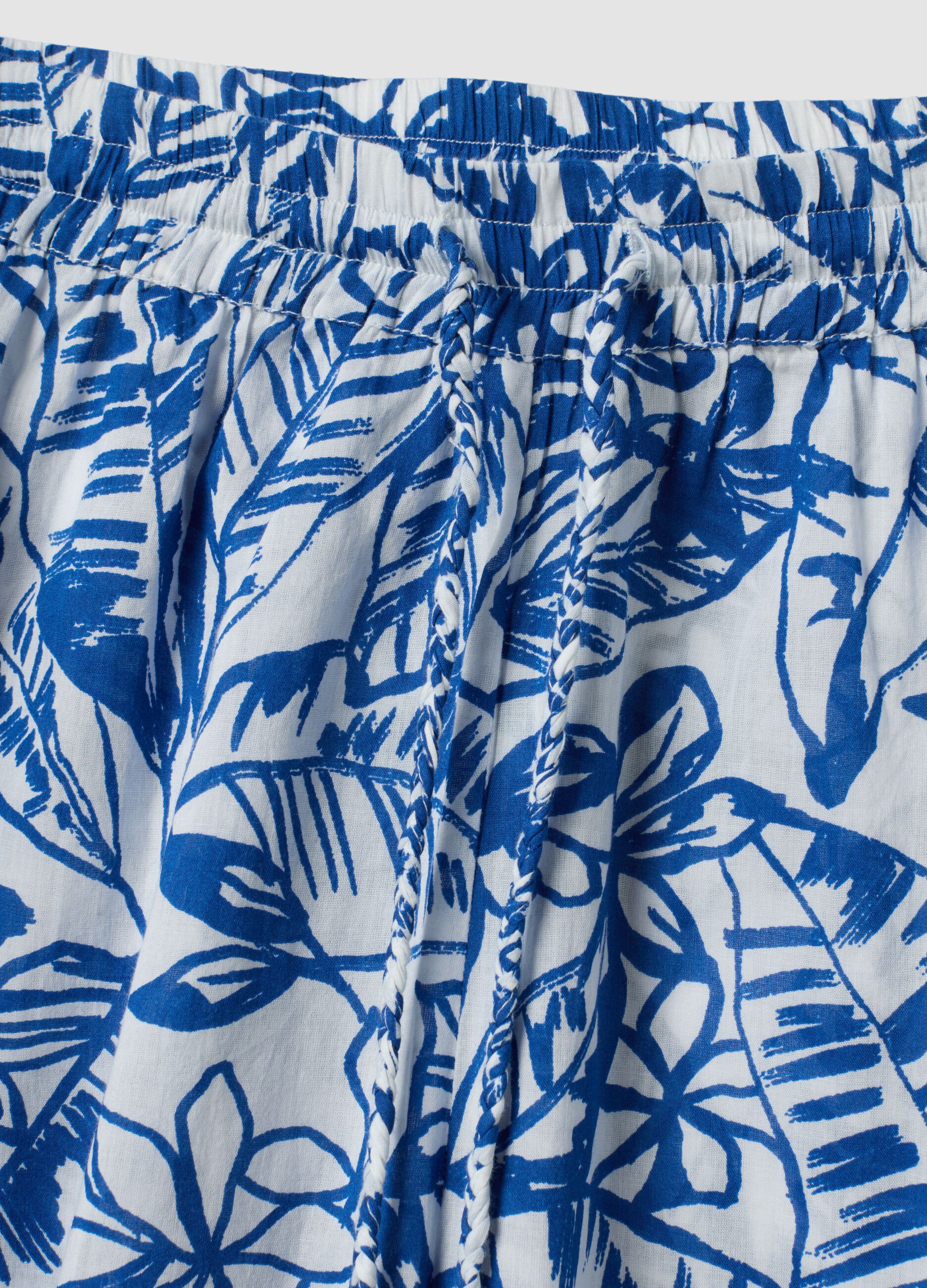 Blue and white organic cotton trousers with floral print