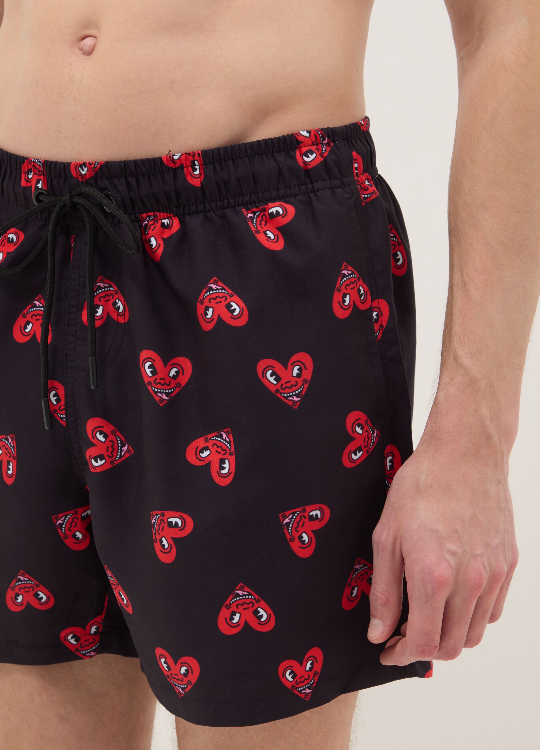 Black beach boxers with Keith Haring heart prints