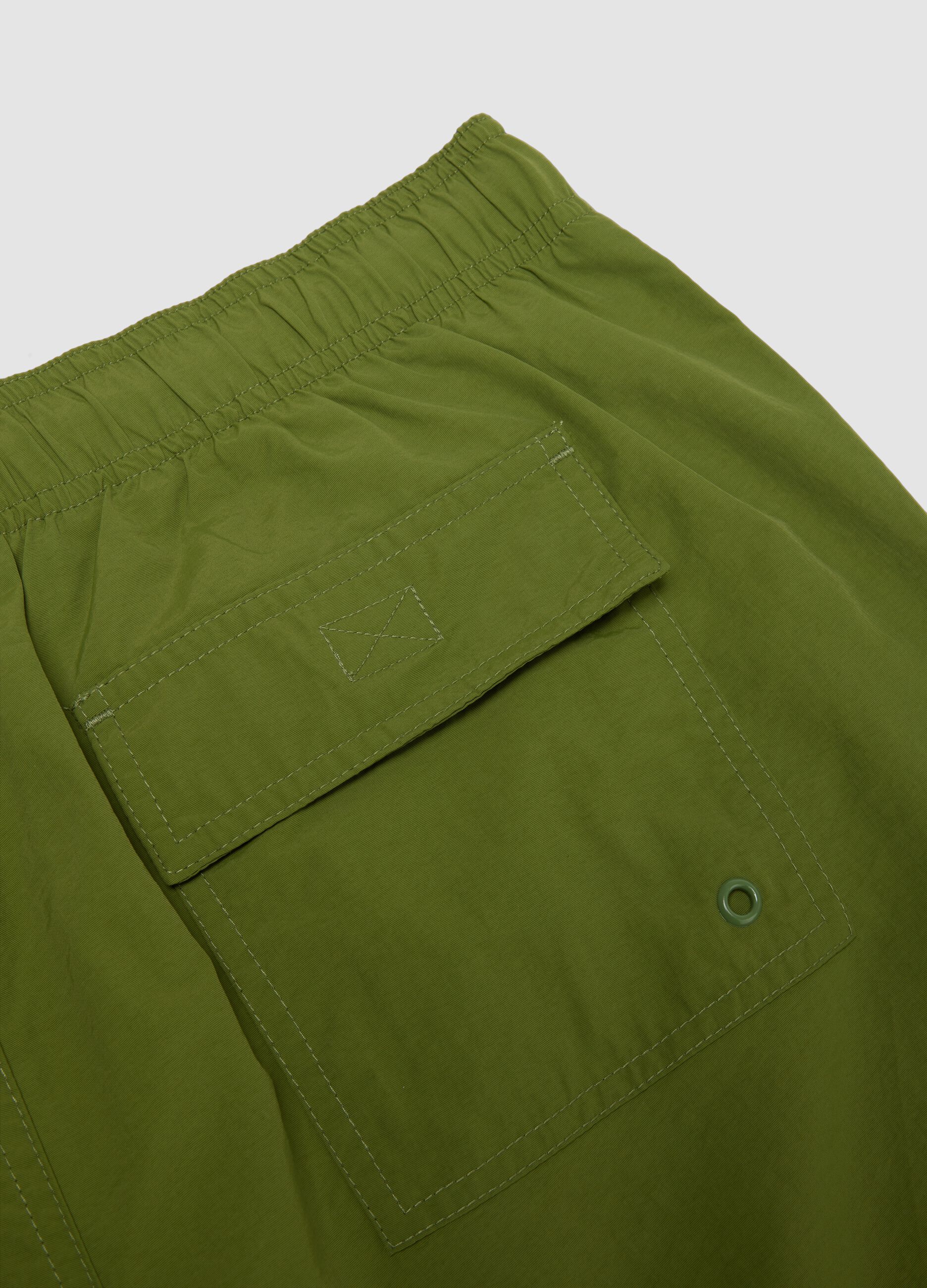 Green swim shorts with elasticated waistband and drawstring
