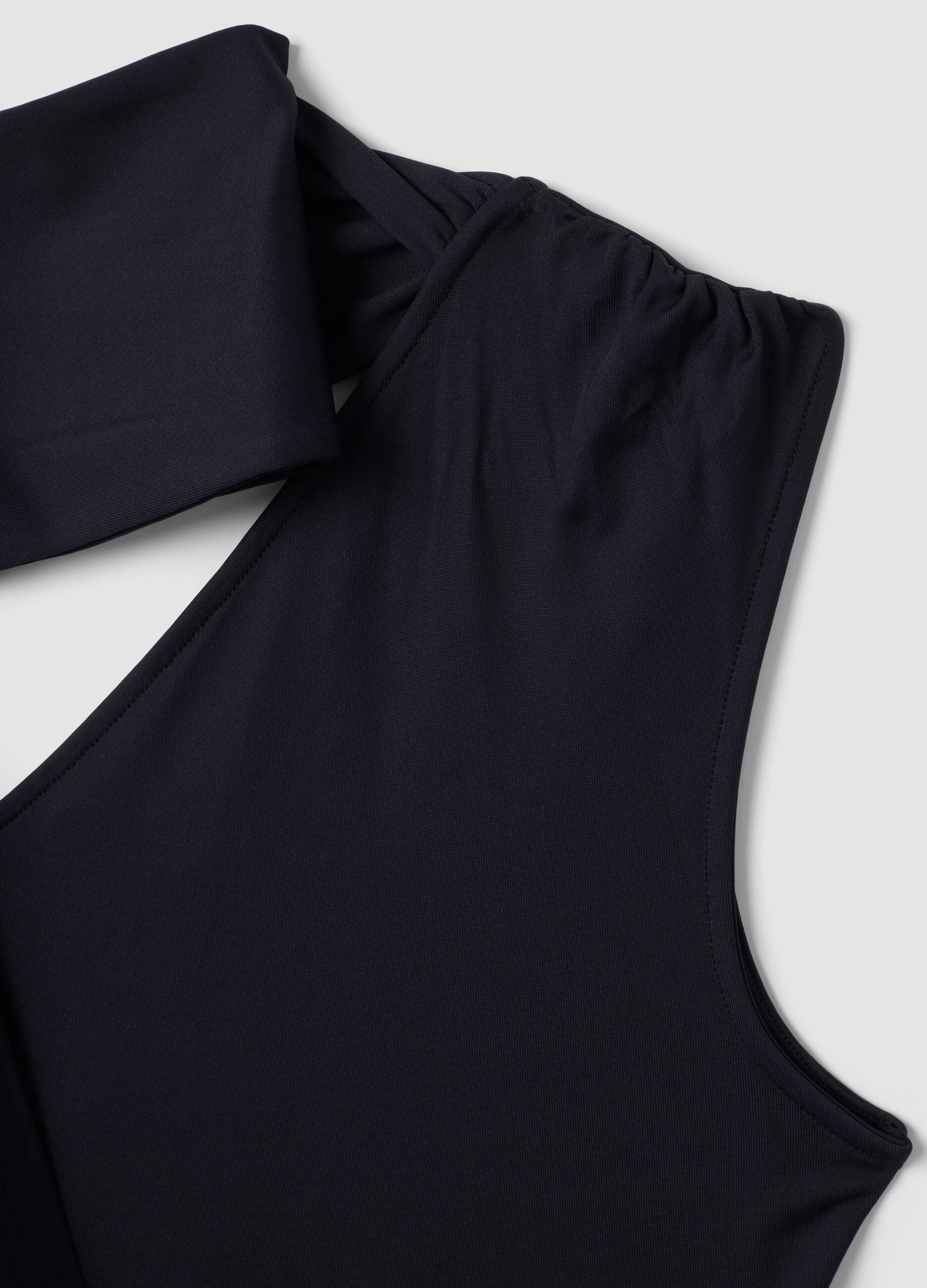 Black stretch top with asymmetric neckline and draped band
