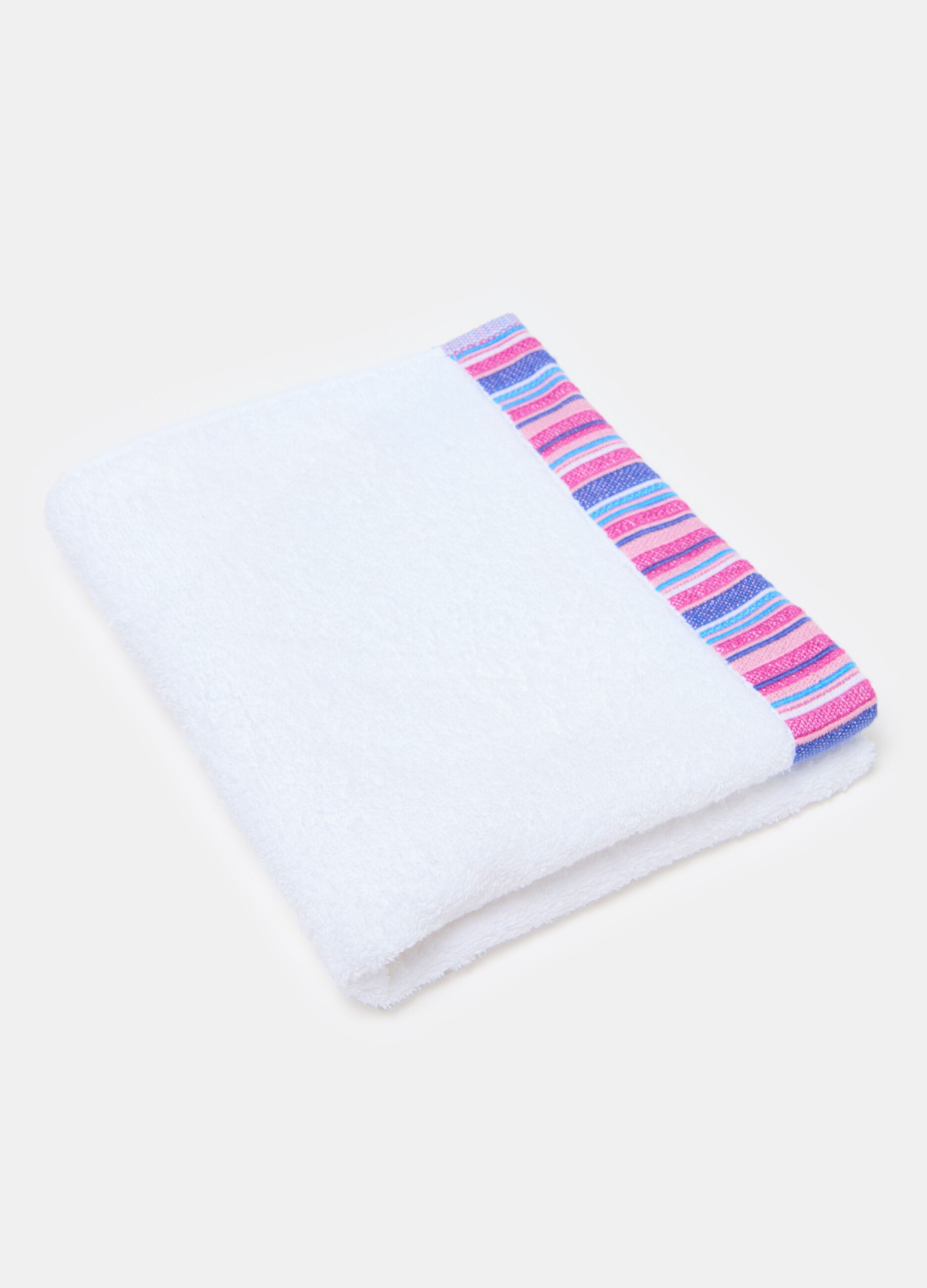 Solid colour face towel with contrasting striped trim