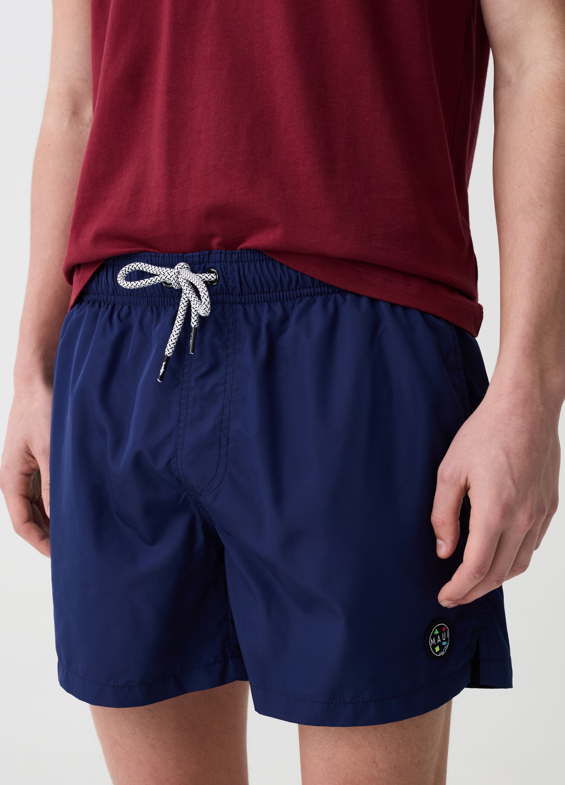 Swimming trunks with logo patch