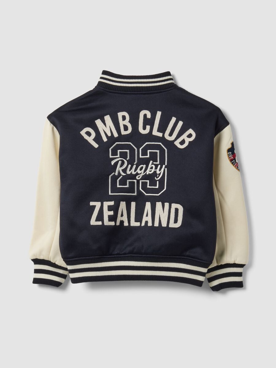 Blue varsity jacket with beige sleeves and print for boys_2