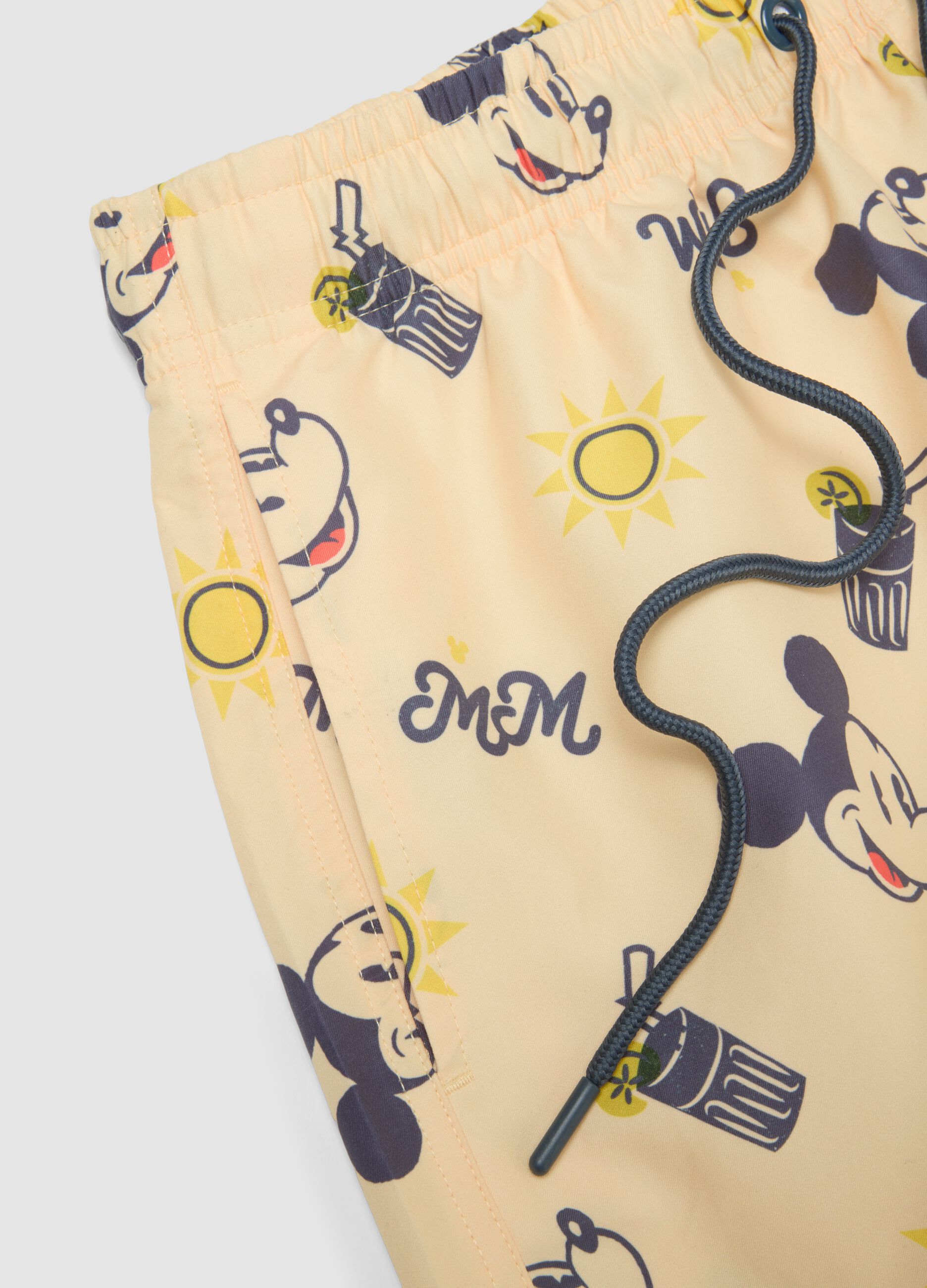 Orange swim trunks with Mickey Mouse prints