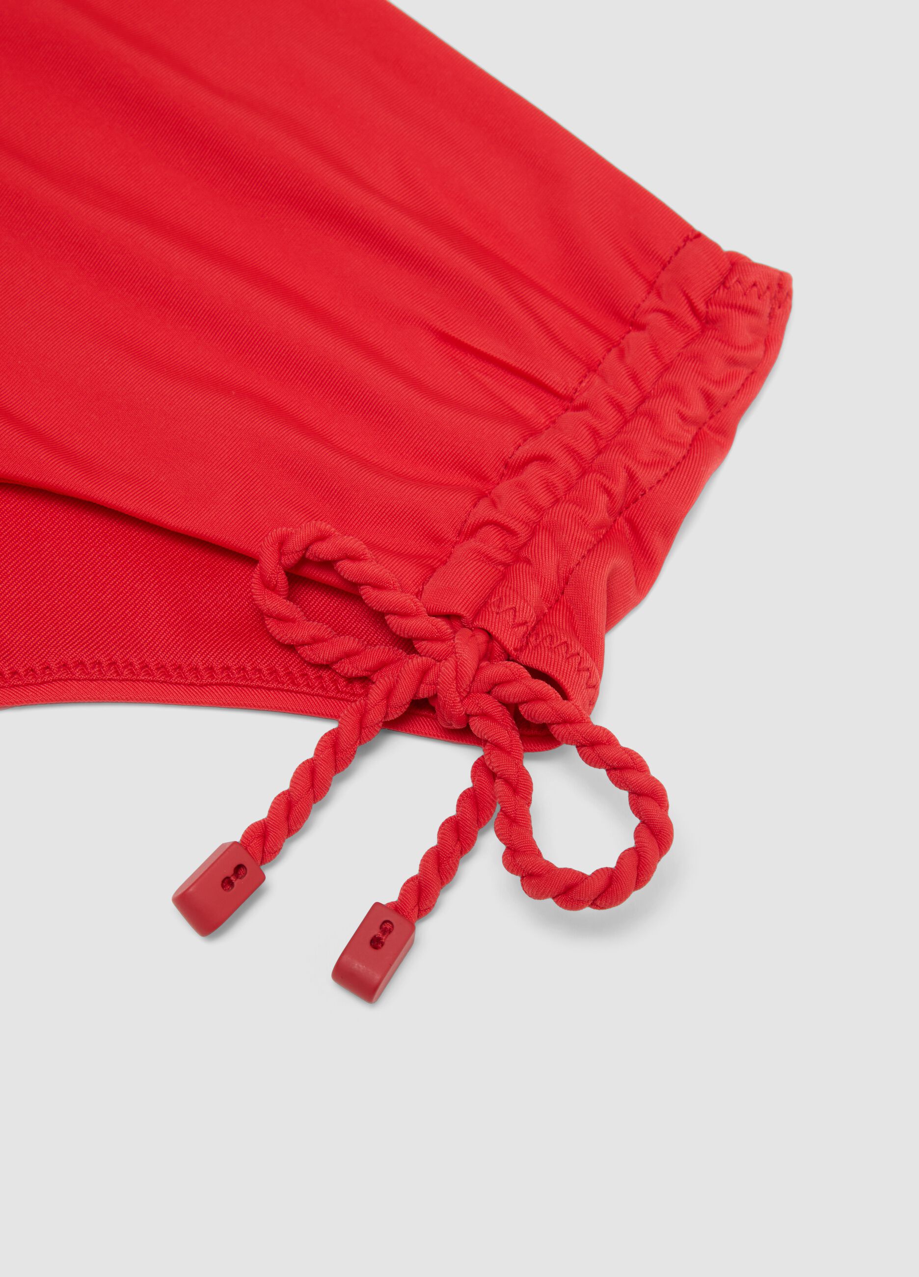 Red bikini bottoms in stretch fabric with side ties