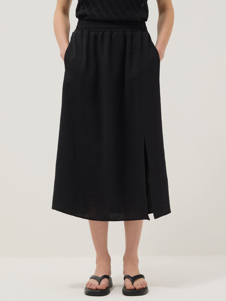 Black long skirt with regular fit, elasticated waist and slit_1