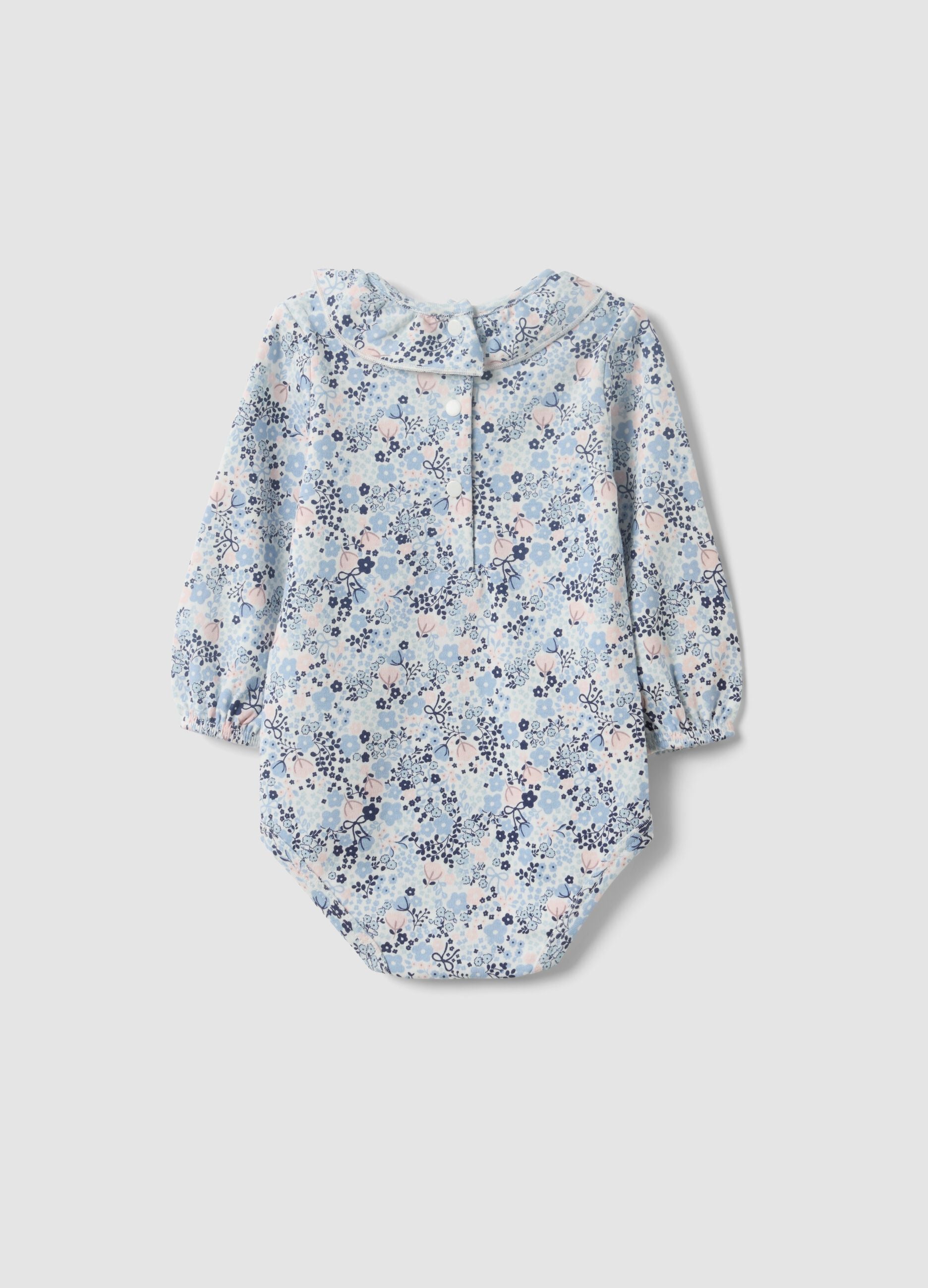 Body branco de algod&atilde;o org&acirc;nico para beb&eacute; menina com gola com folhos e estampado floral
