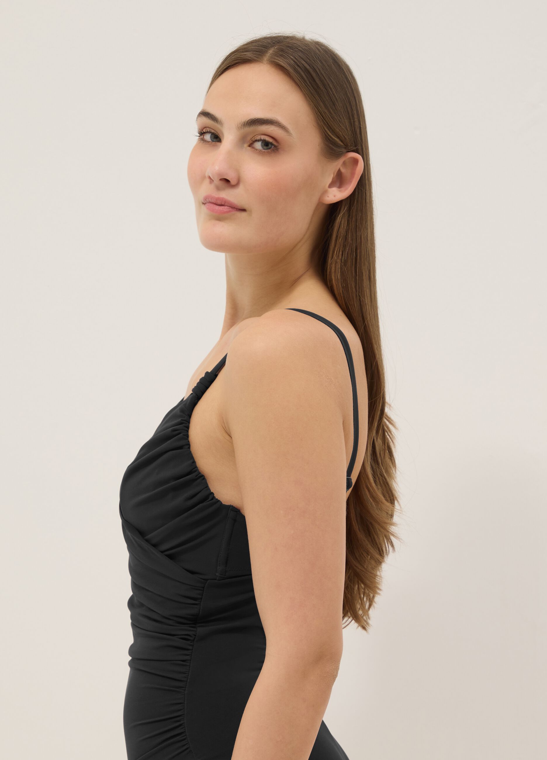 Black draped stretch swimsuit with shaping effect