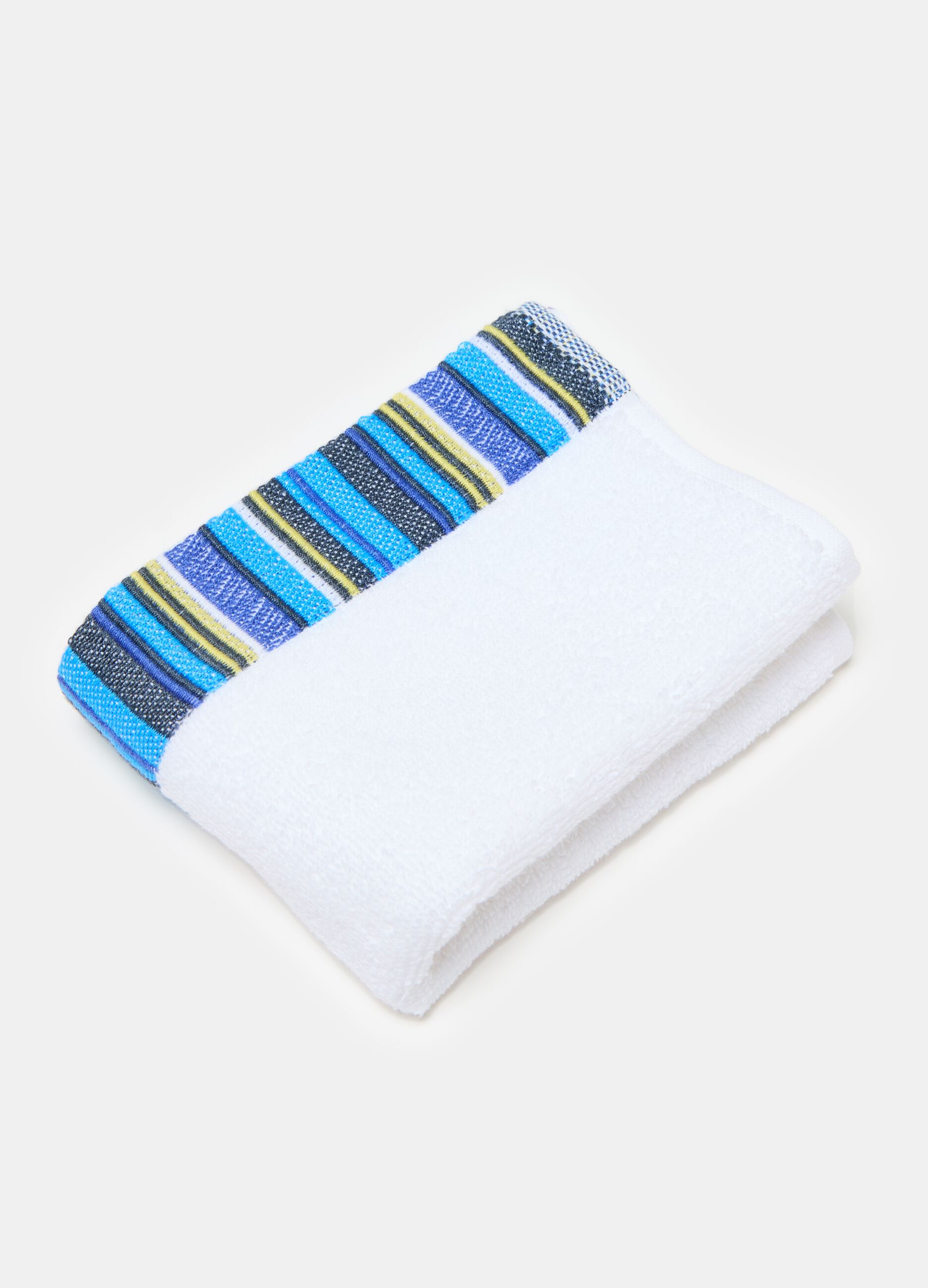 Solid colour guest towel with contrasting striped trim