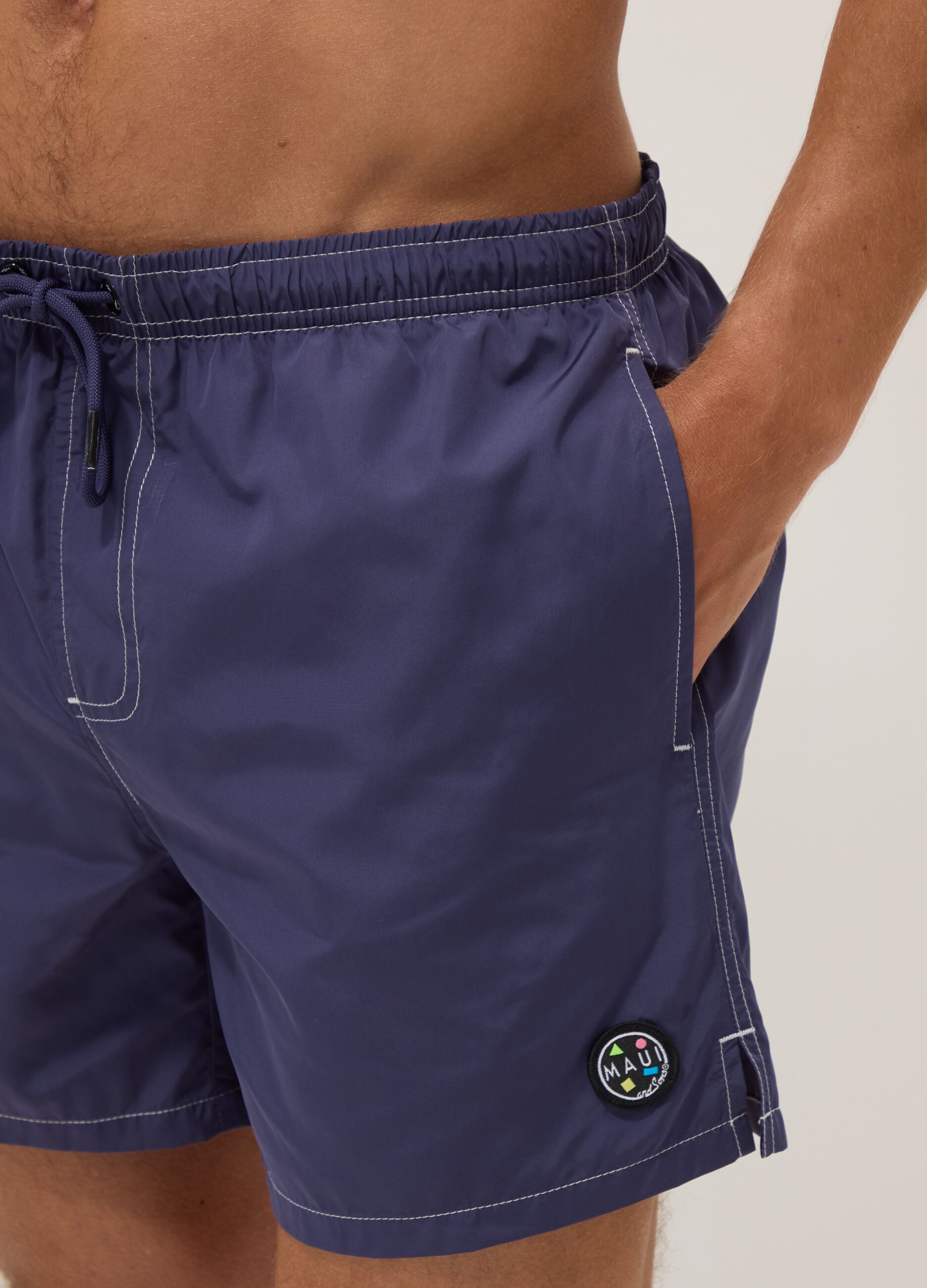 Blue swim shorts with drawstring waist