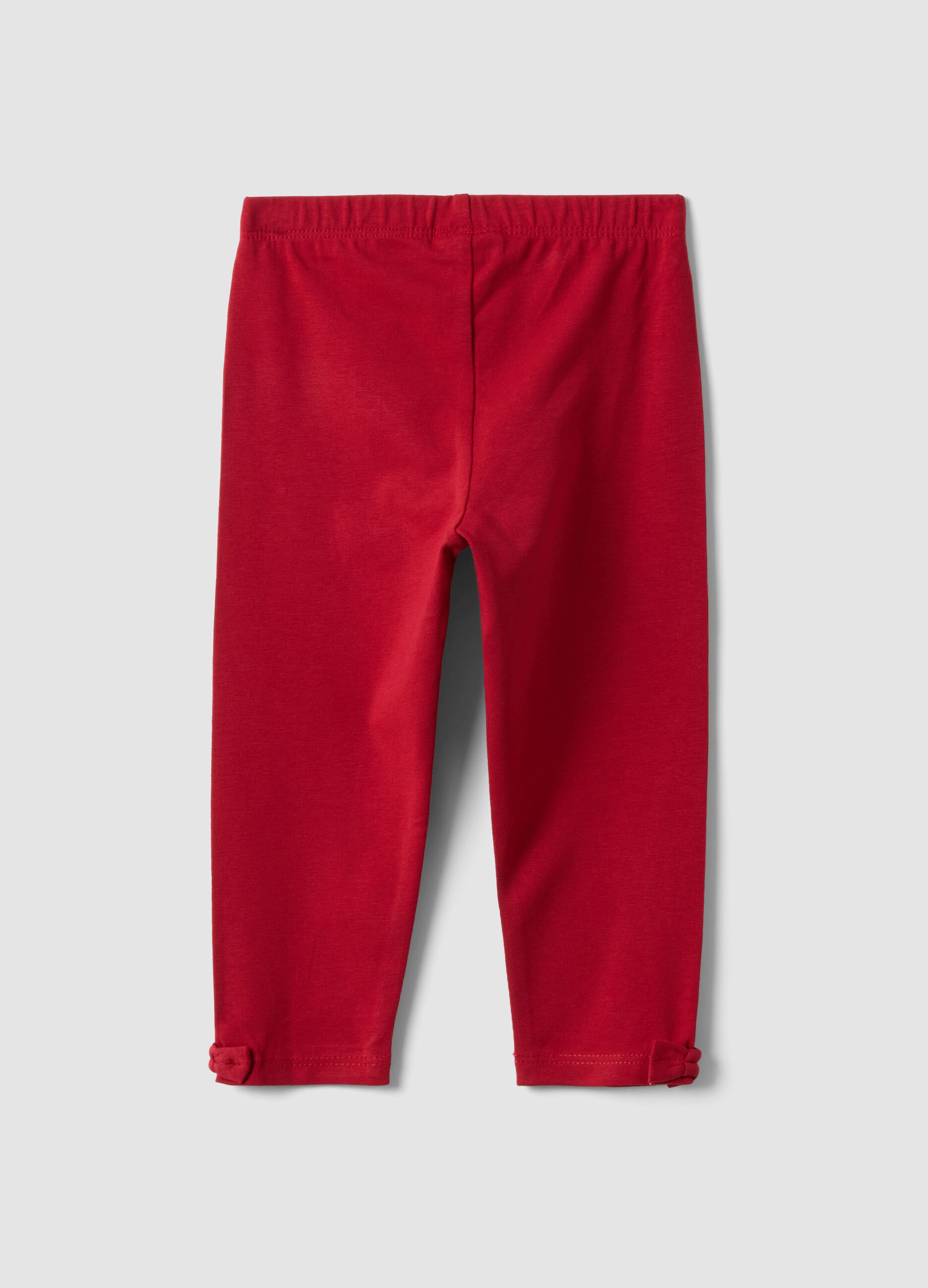 Red stretch organic cotton leggings with bow details for baby girl