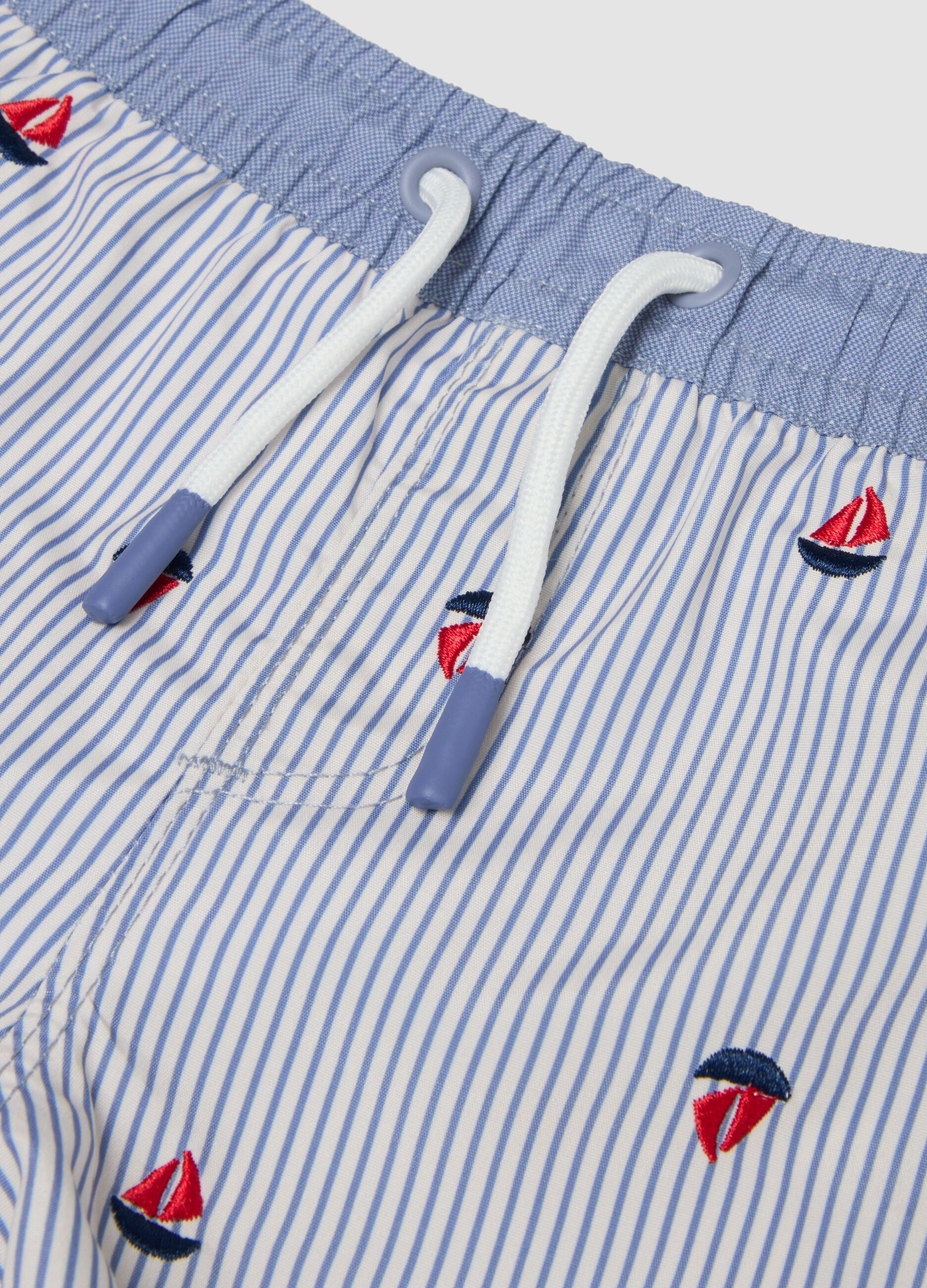 Blue striped baby swim shorts with embroidered boats