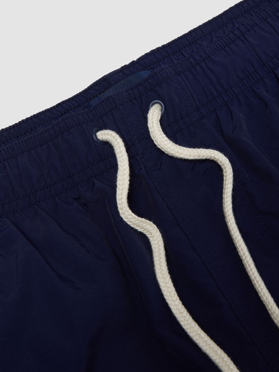 Blue swim shorts with elasticated waistband and drawstring_1
