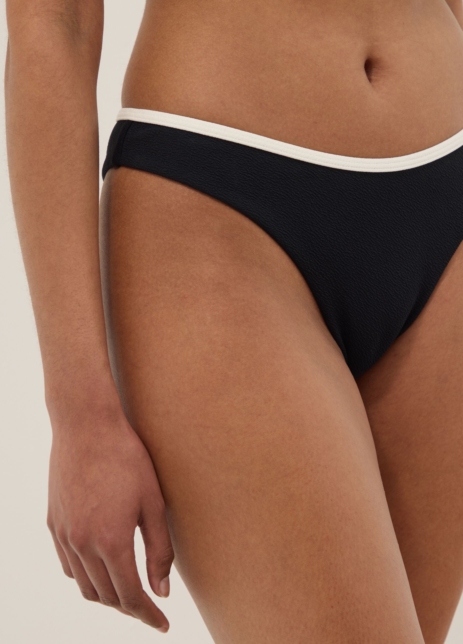 Black stretch swim briefs with white trim