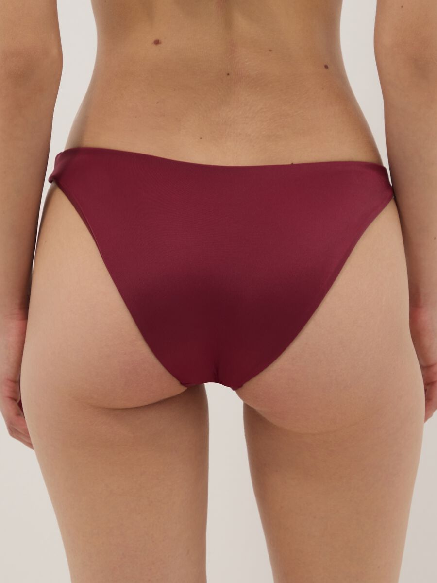 Red stretch bikini bottoms with gold-tone ring detail_2