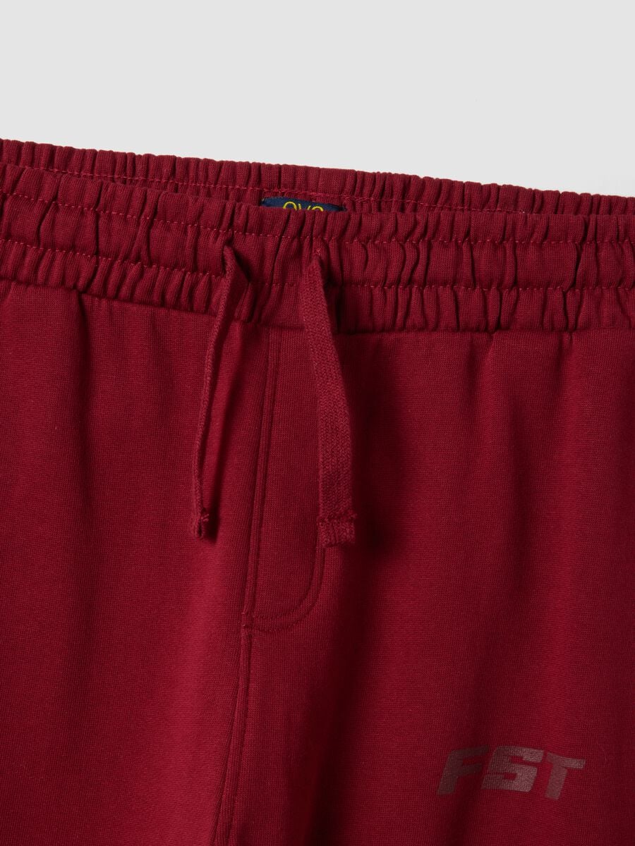 Red relaxed-fit joggers in pure organic cotton with check print_1