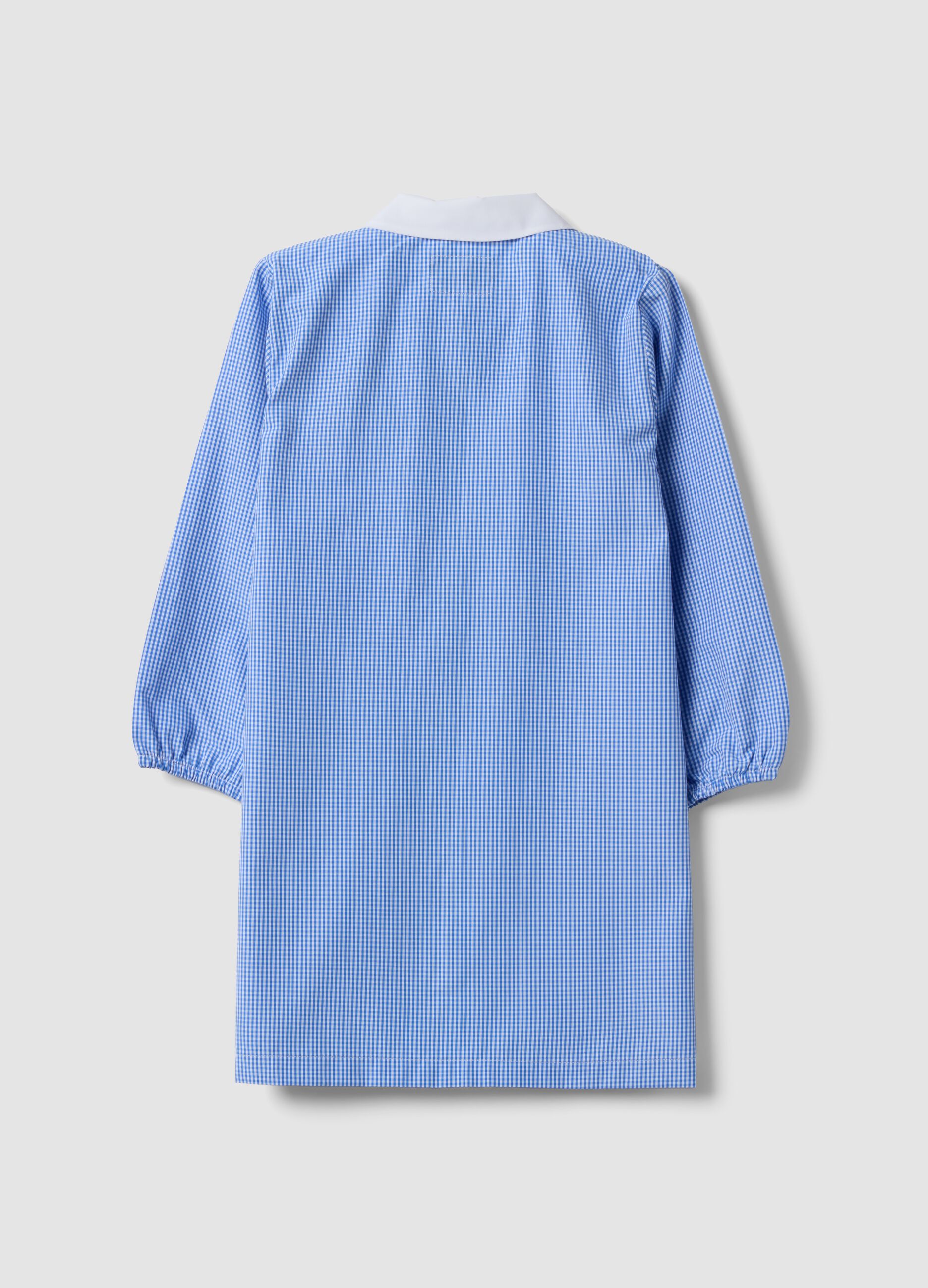 Light blue gingham nursery apron with zip and machine embroidery