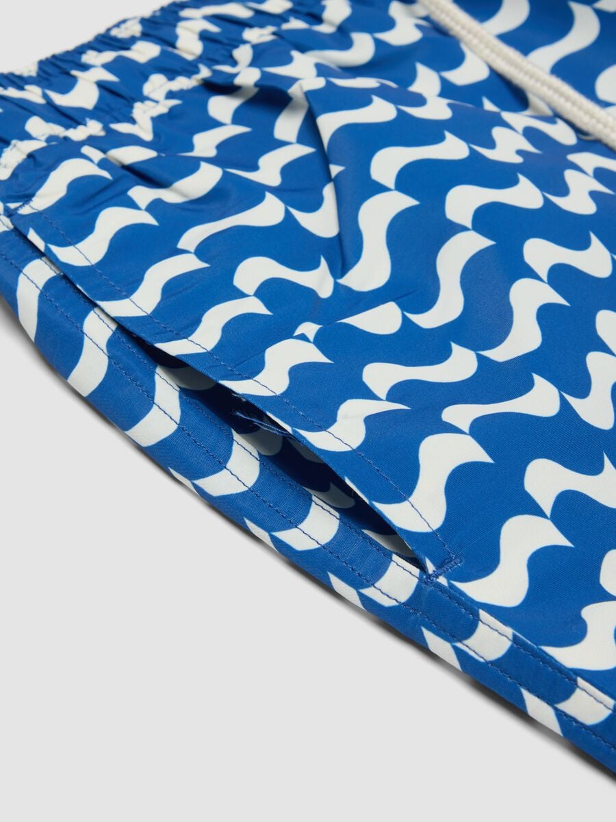 Blue swim shorts with wave pattern_5