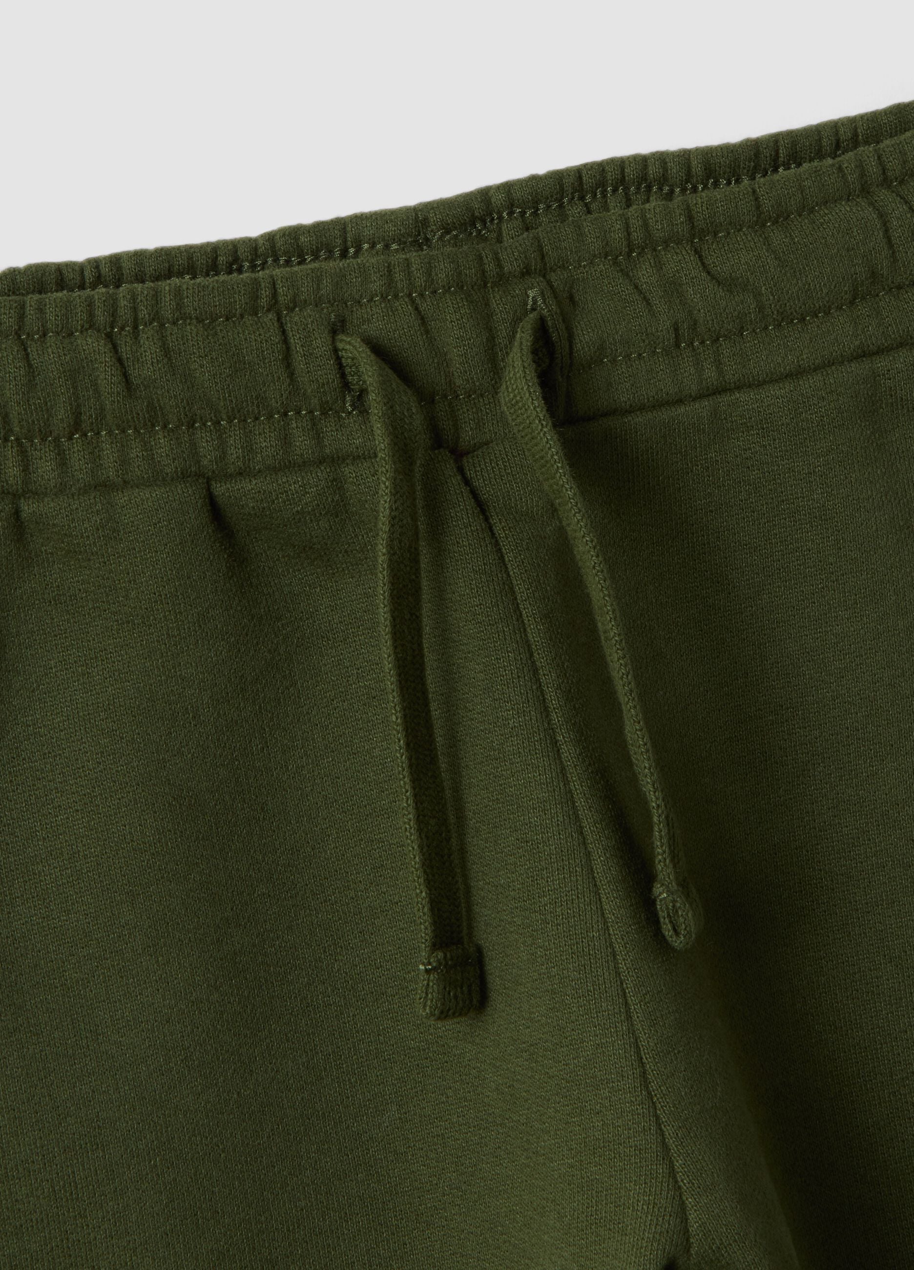 Cal&ccedil;as jogger verdes em algod&atilde;o puro, corte over, com estampado de ursinho