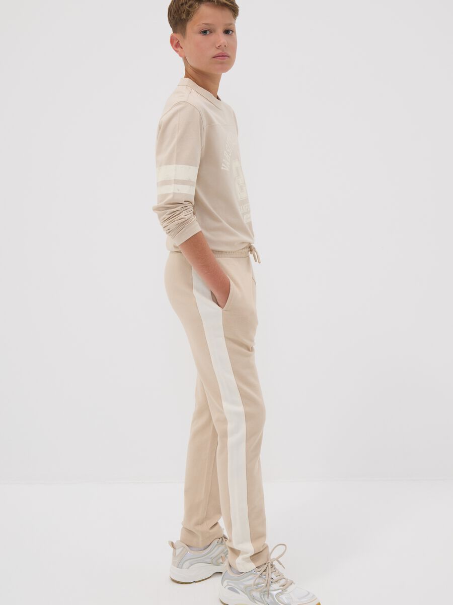 Beige pure cotton jogger trousers with side stripes for boys_2