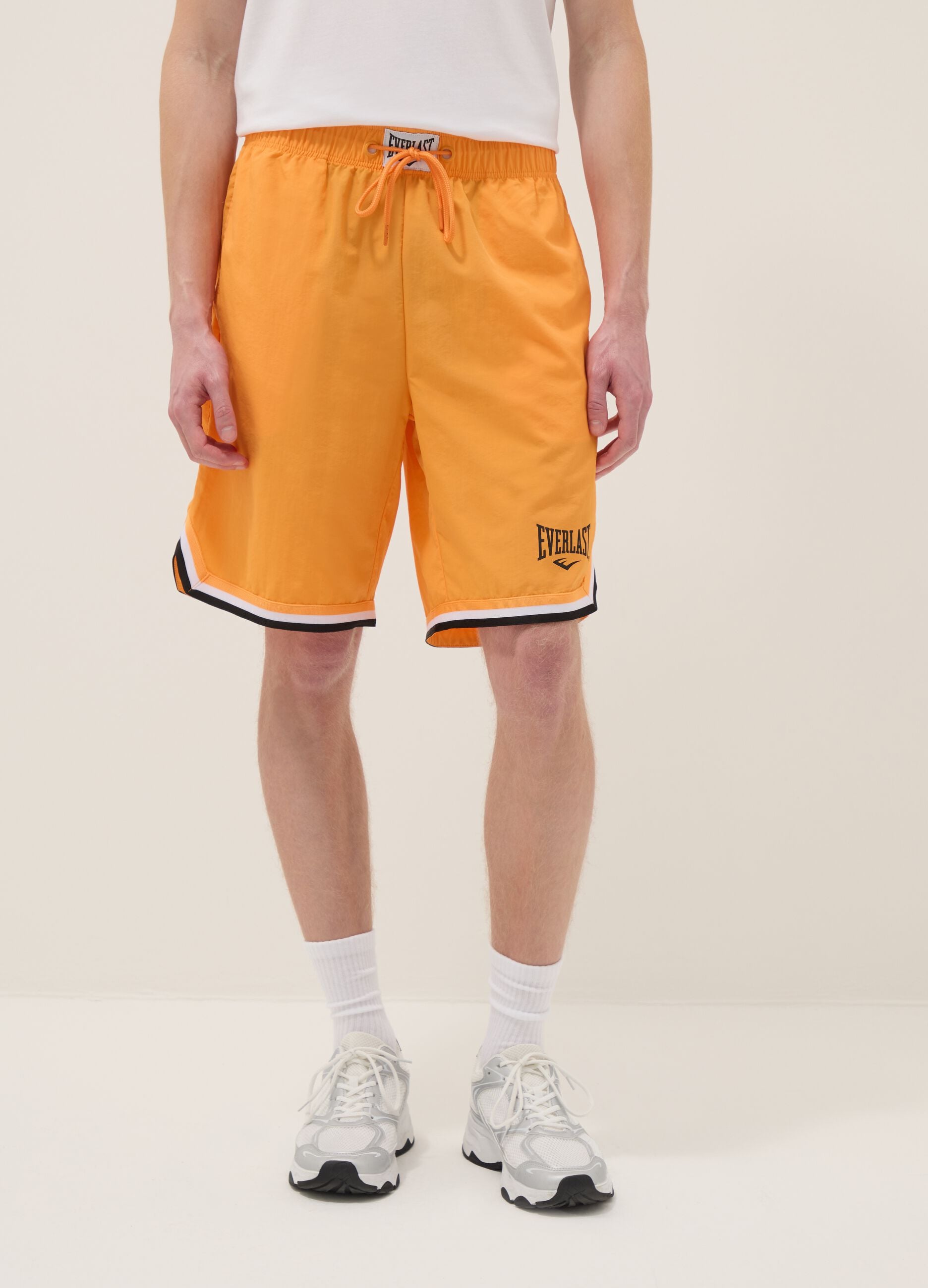 Orange regular fit sports shorts with white and black details