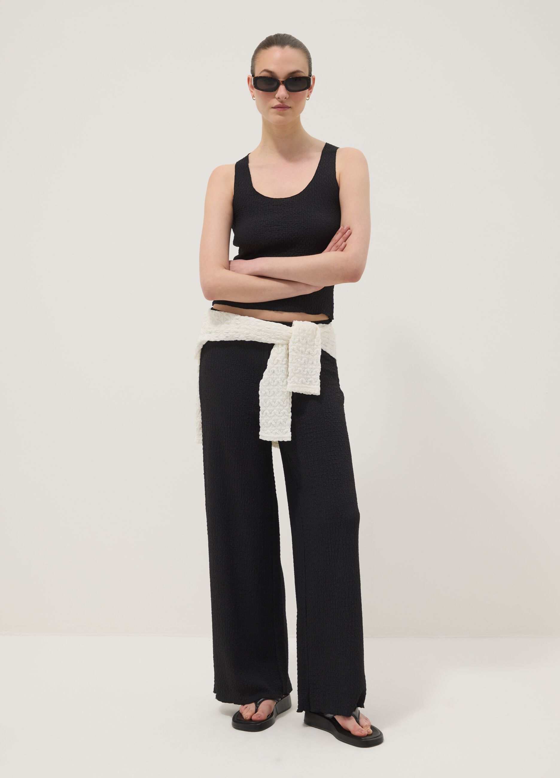 Black stretchy wide-leg trousers with crinkled texture
