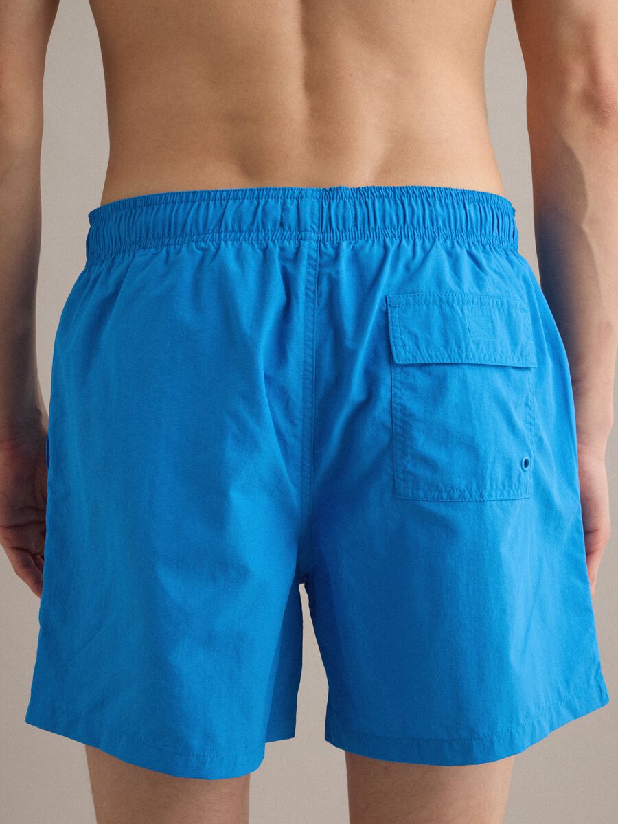 Blue swim shorts with elasticated waistband and contrast drawstring_4