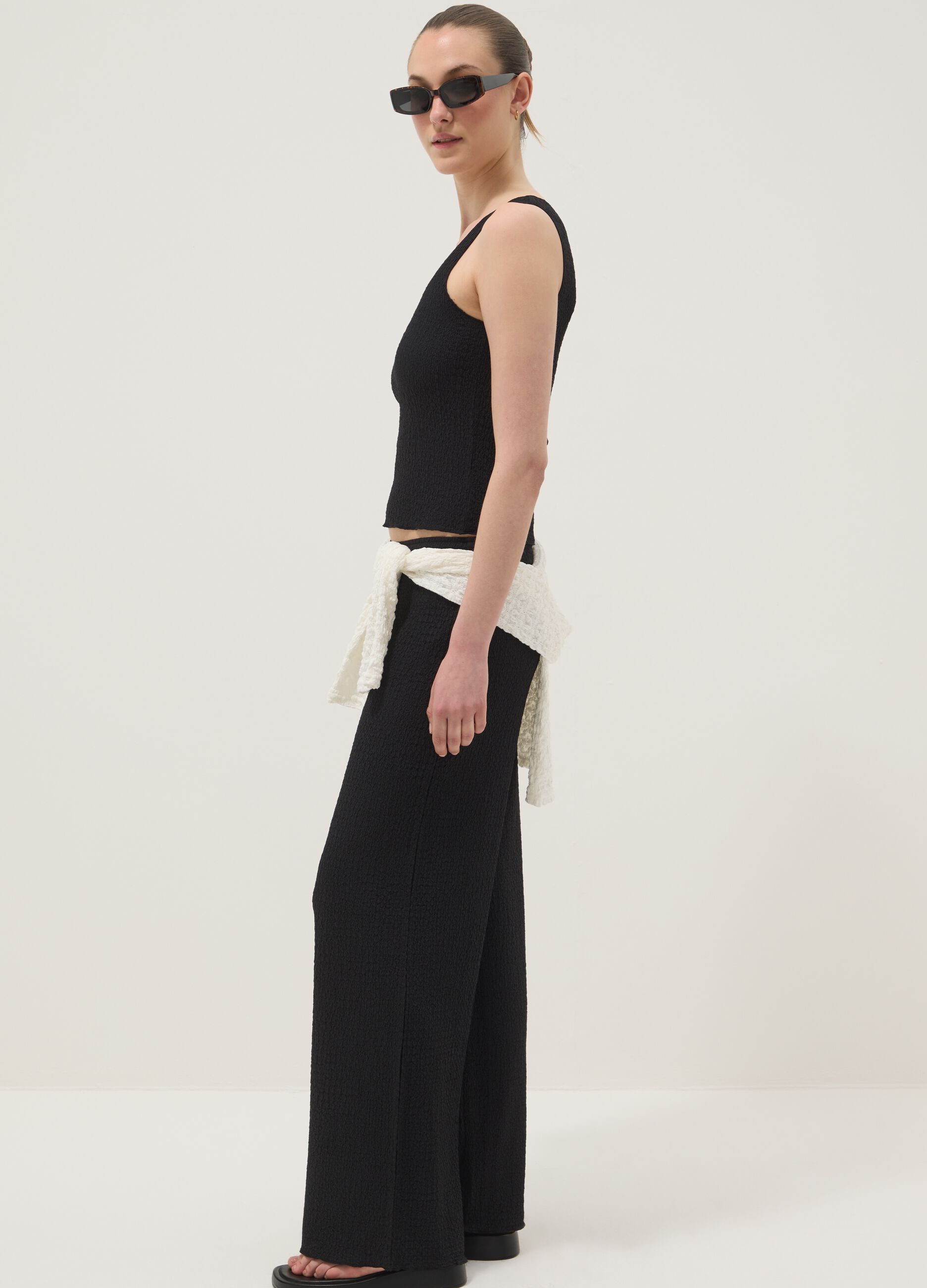 Black stretchy wide-leg trousers with crinkled texture