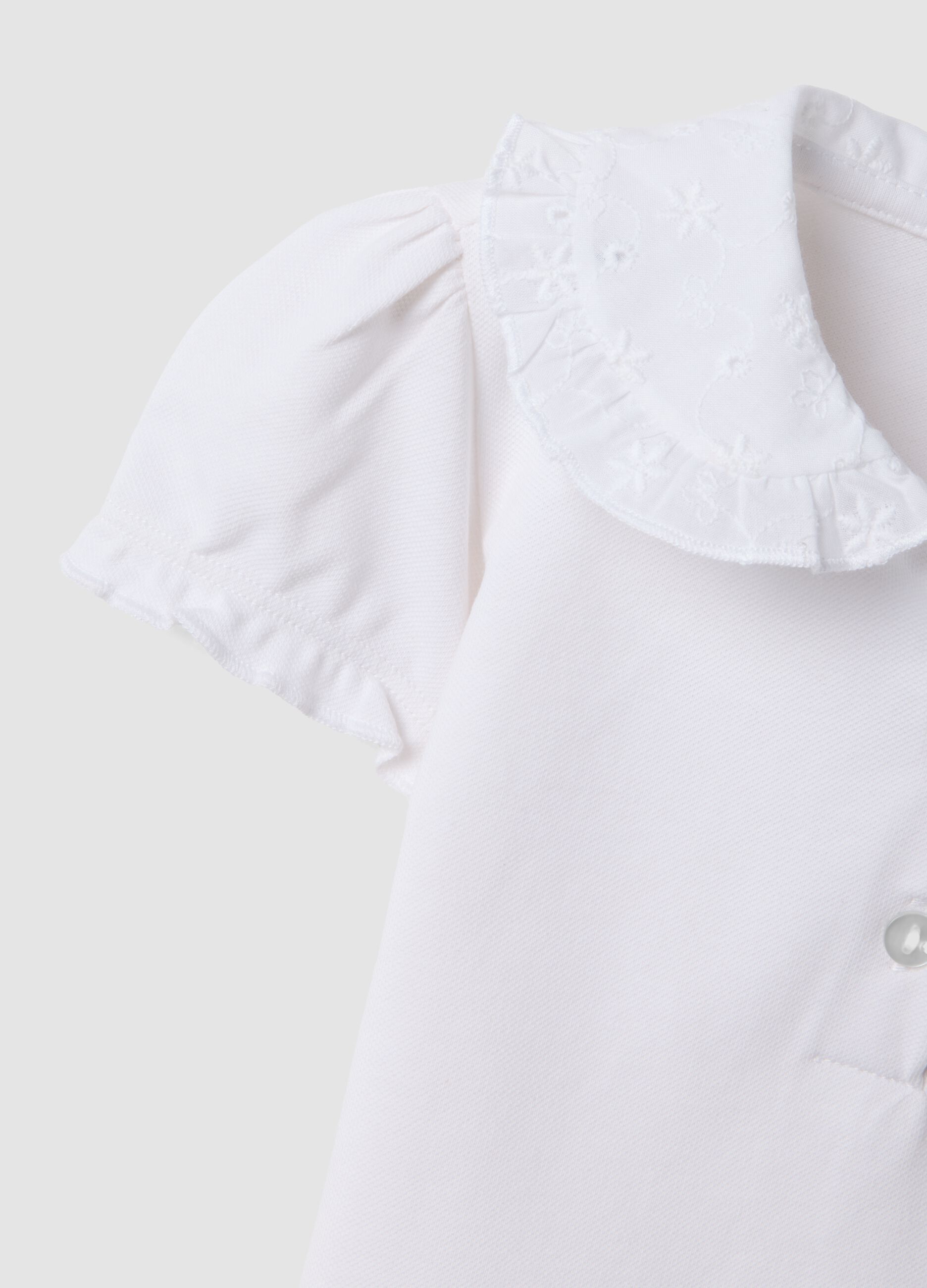 White short-sleeve stretch-cotton polo with ruffled collar
