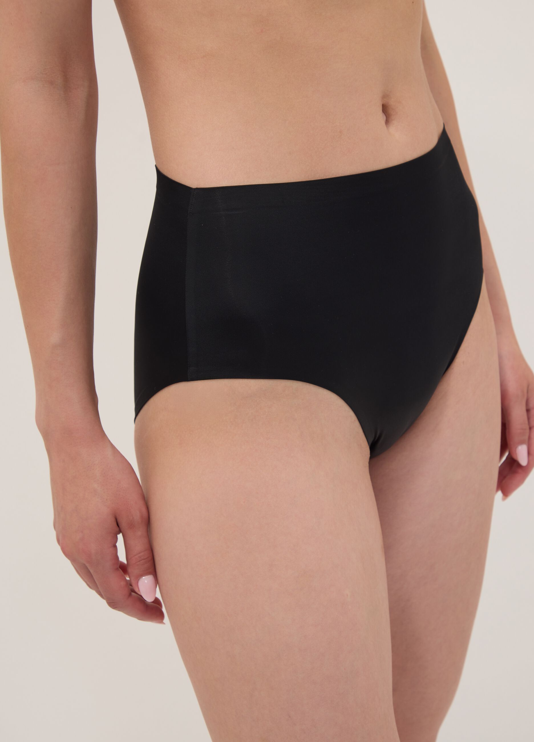 Black high-waisted Brazilian briefs in stretch fabric with a shaping effect
