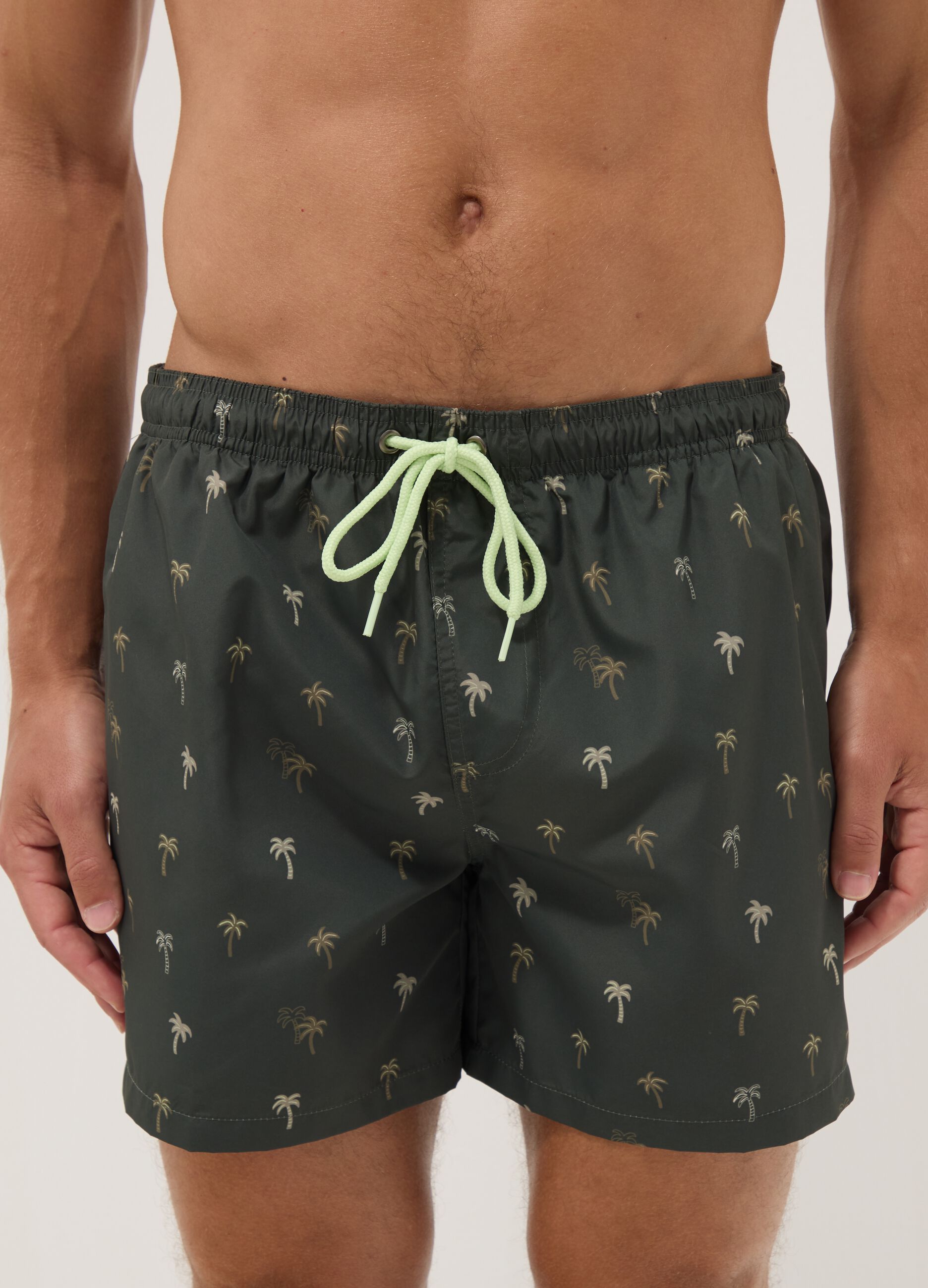 Green boxer swim shorts with palm print