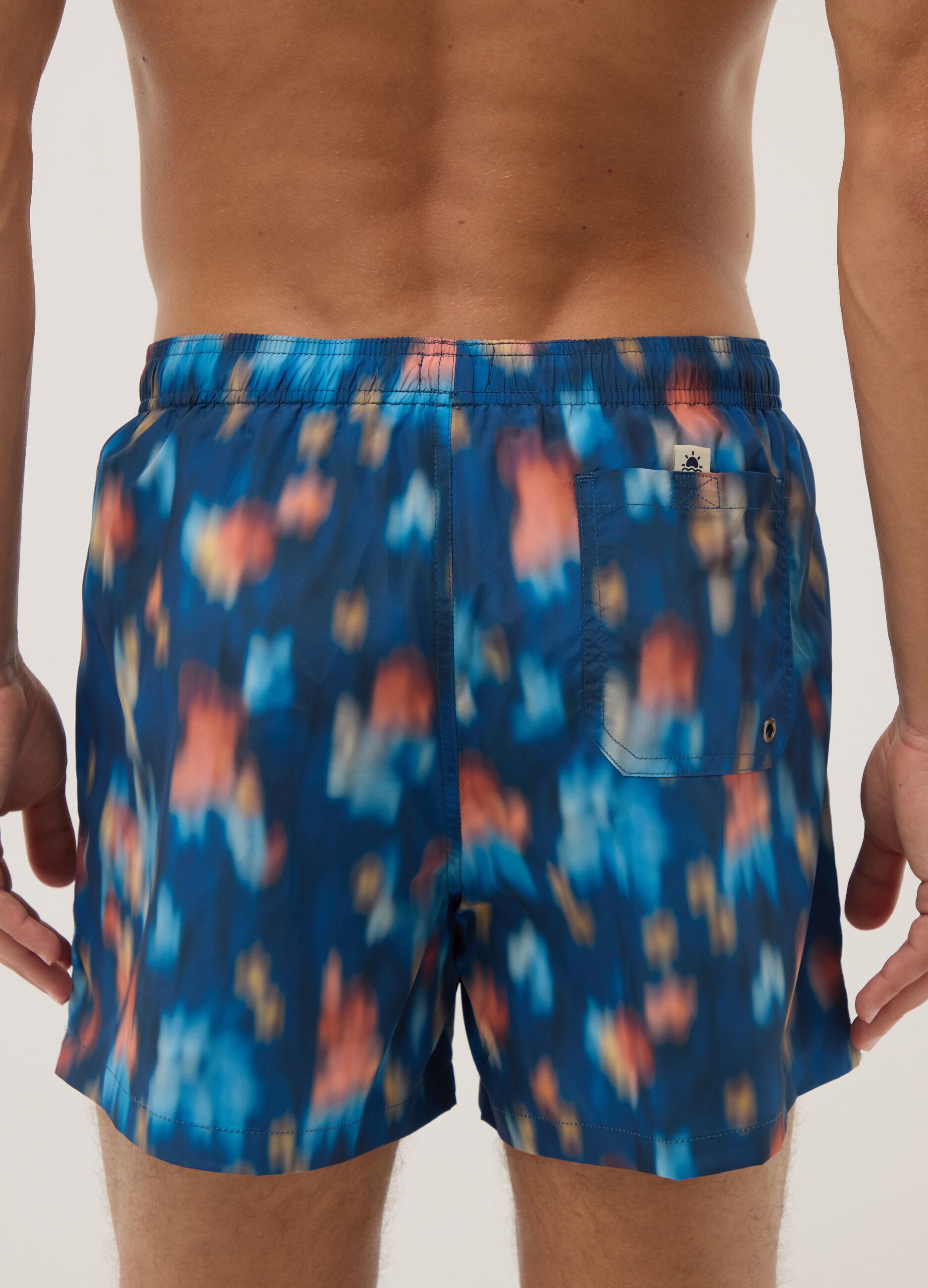 Blue boxer swim shorts with multicolour gradient print