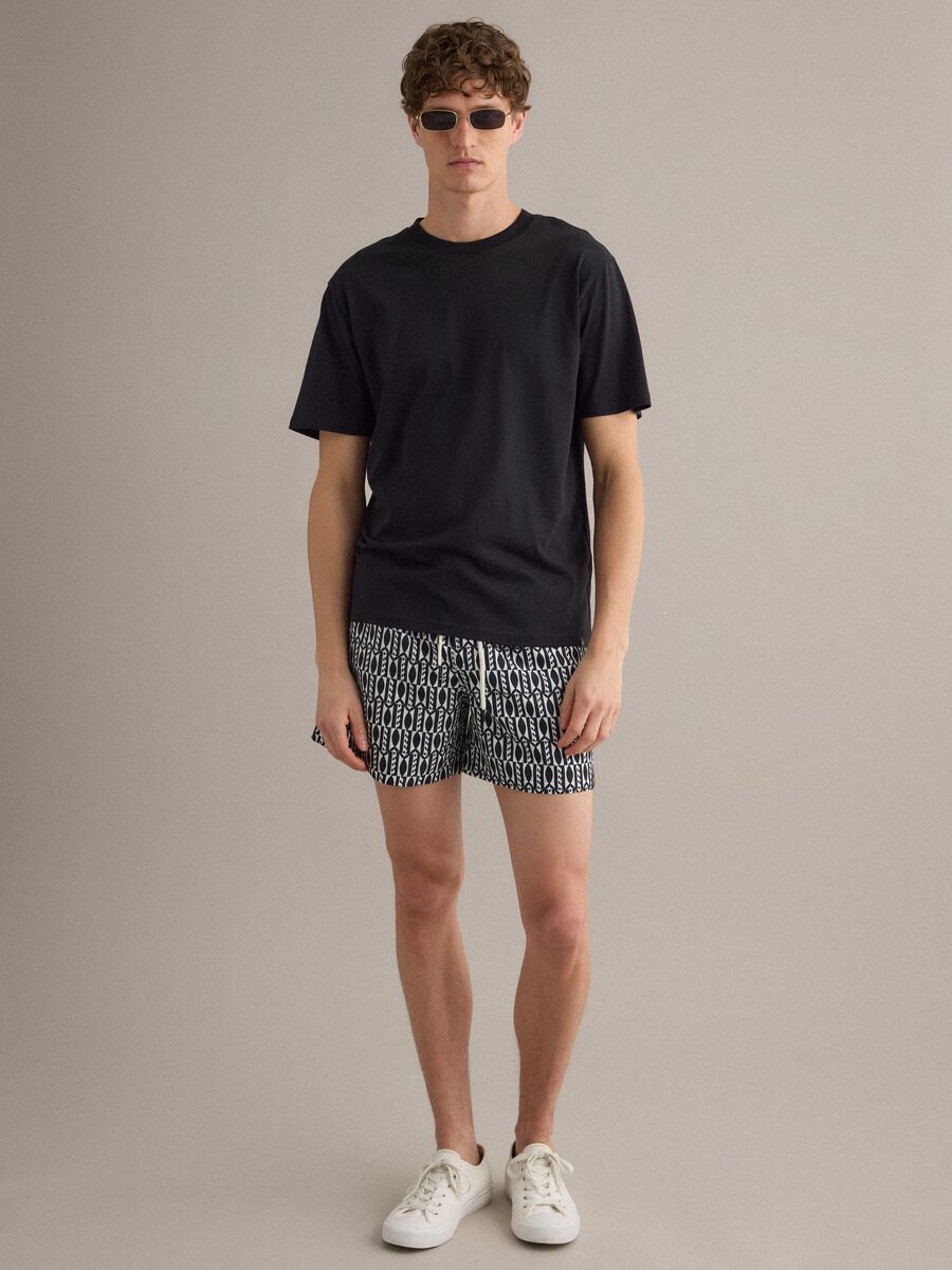 Blue swim shorts with graphic print_0