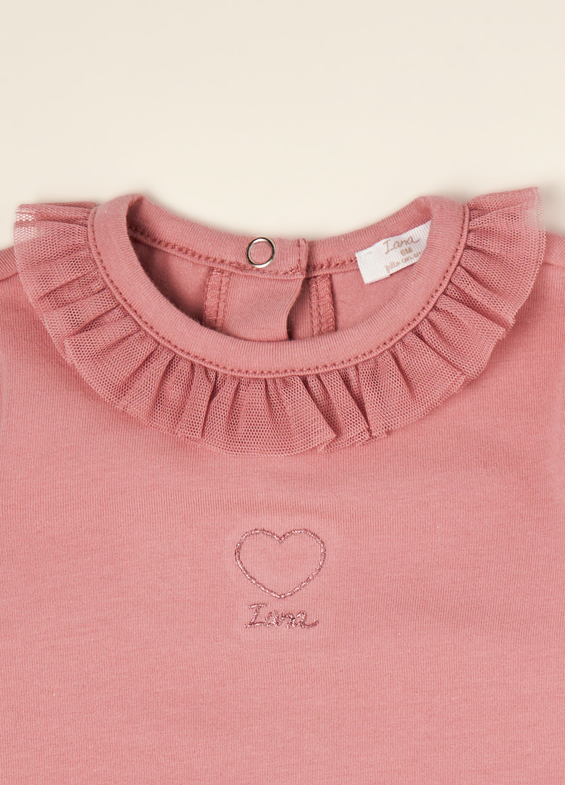 Pink organic stretch cotton bodysuit with ruffled crew neck