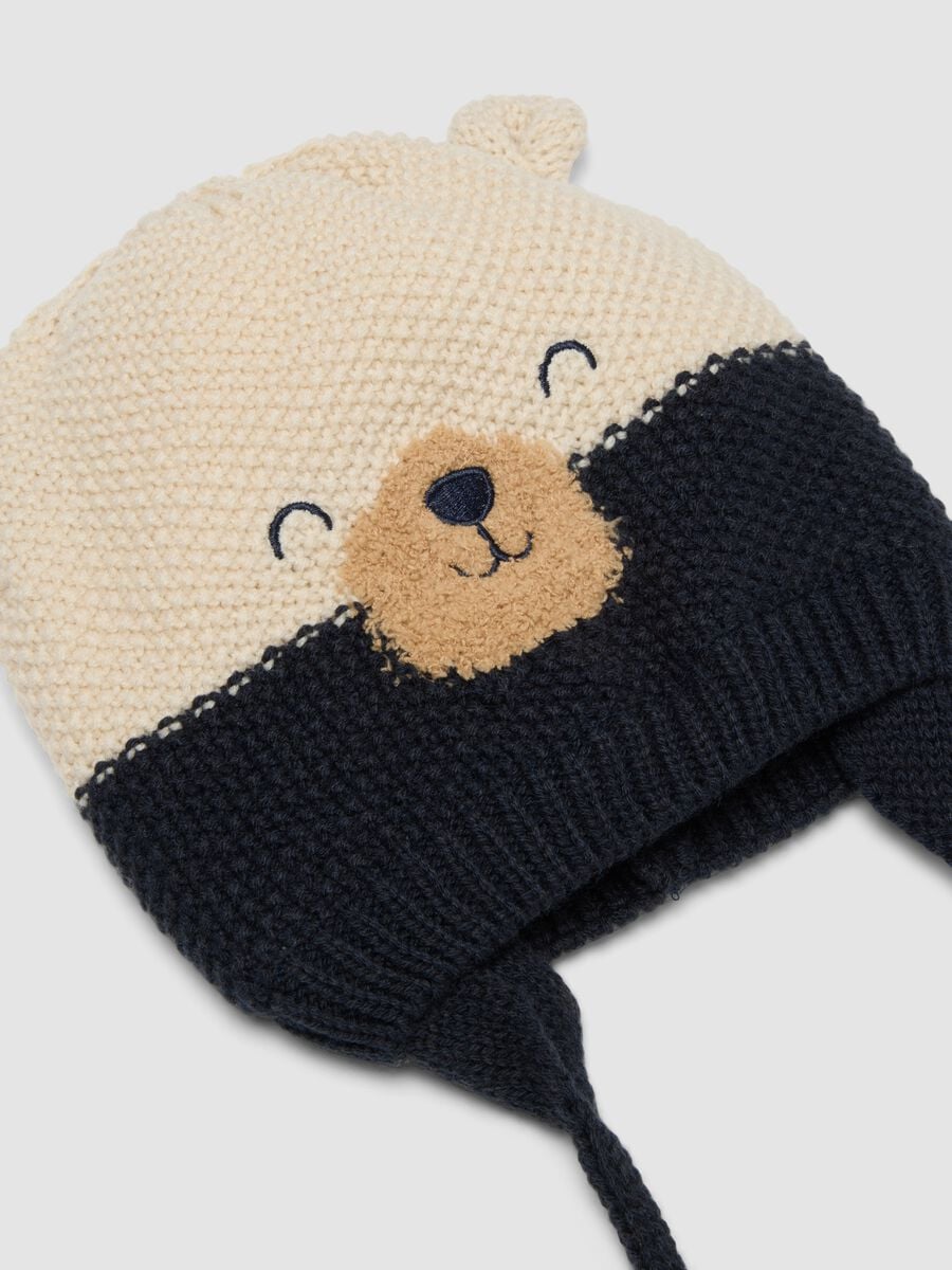 Blue knitted hat with teddy bear motif and ties_1