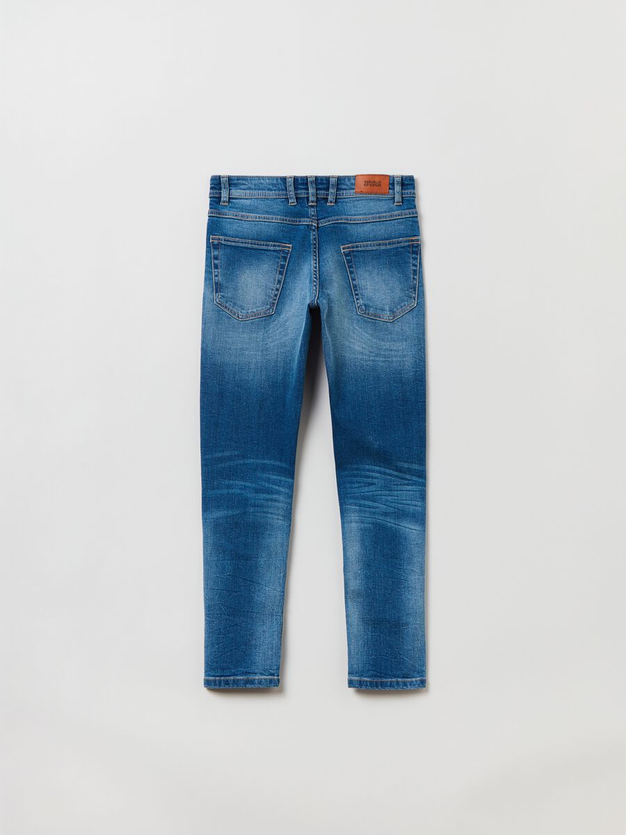 Slim-fit jeans with five pockets and abrasions_1