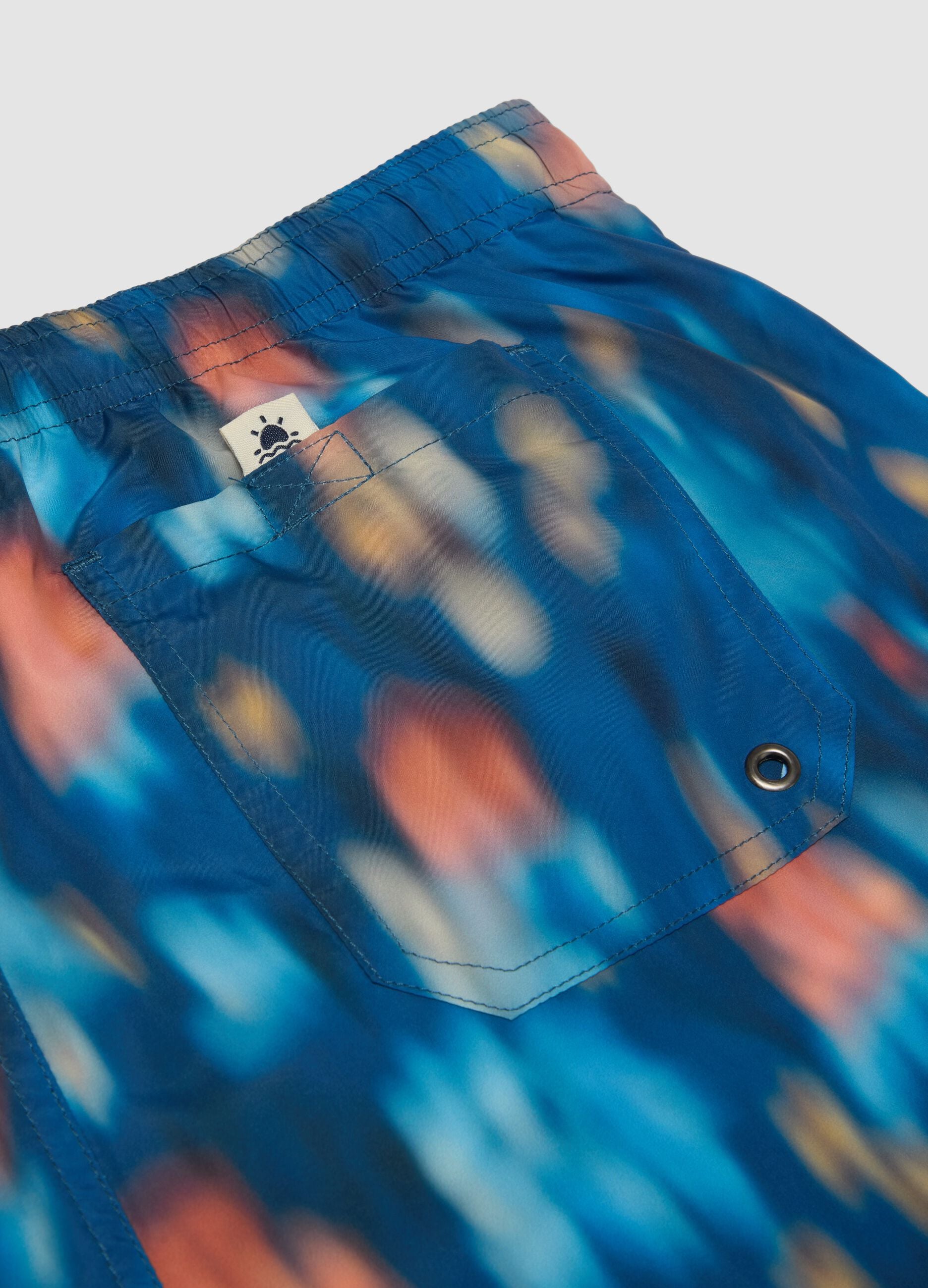 Blue boxer swim shorts with multicolour gradient print